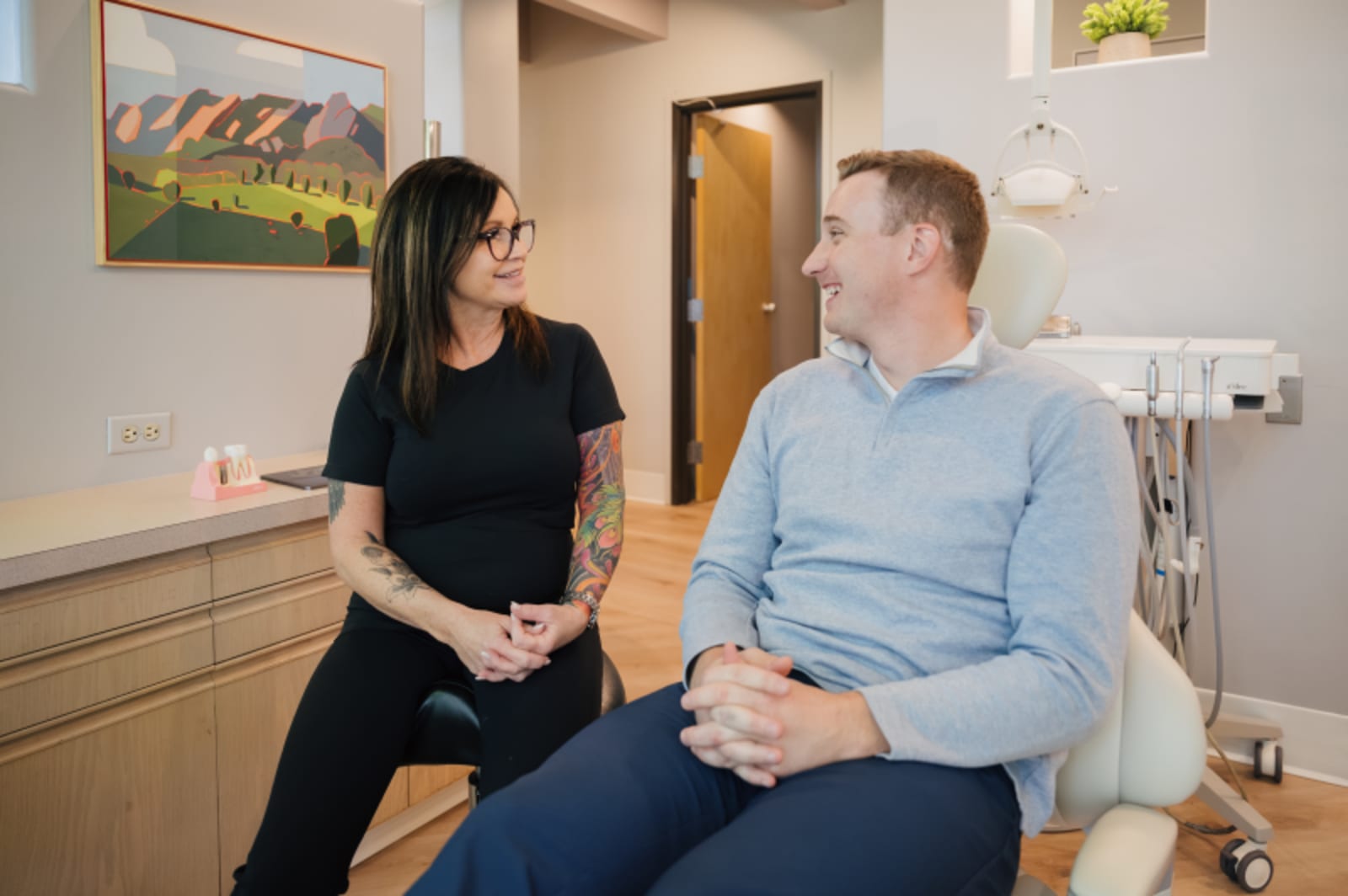 Dentist in consultation with patient discussing treatment options
