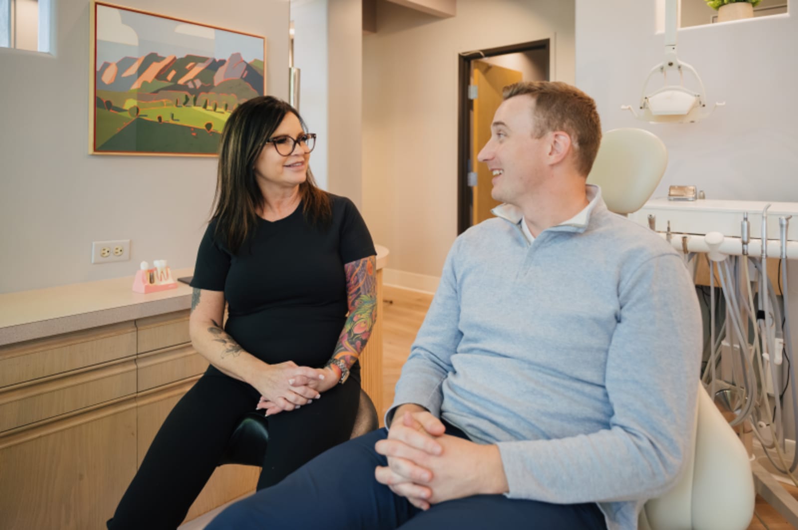 Dentist discussing treatment options with patient in consultation room