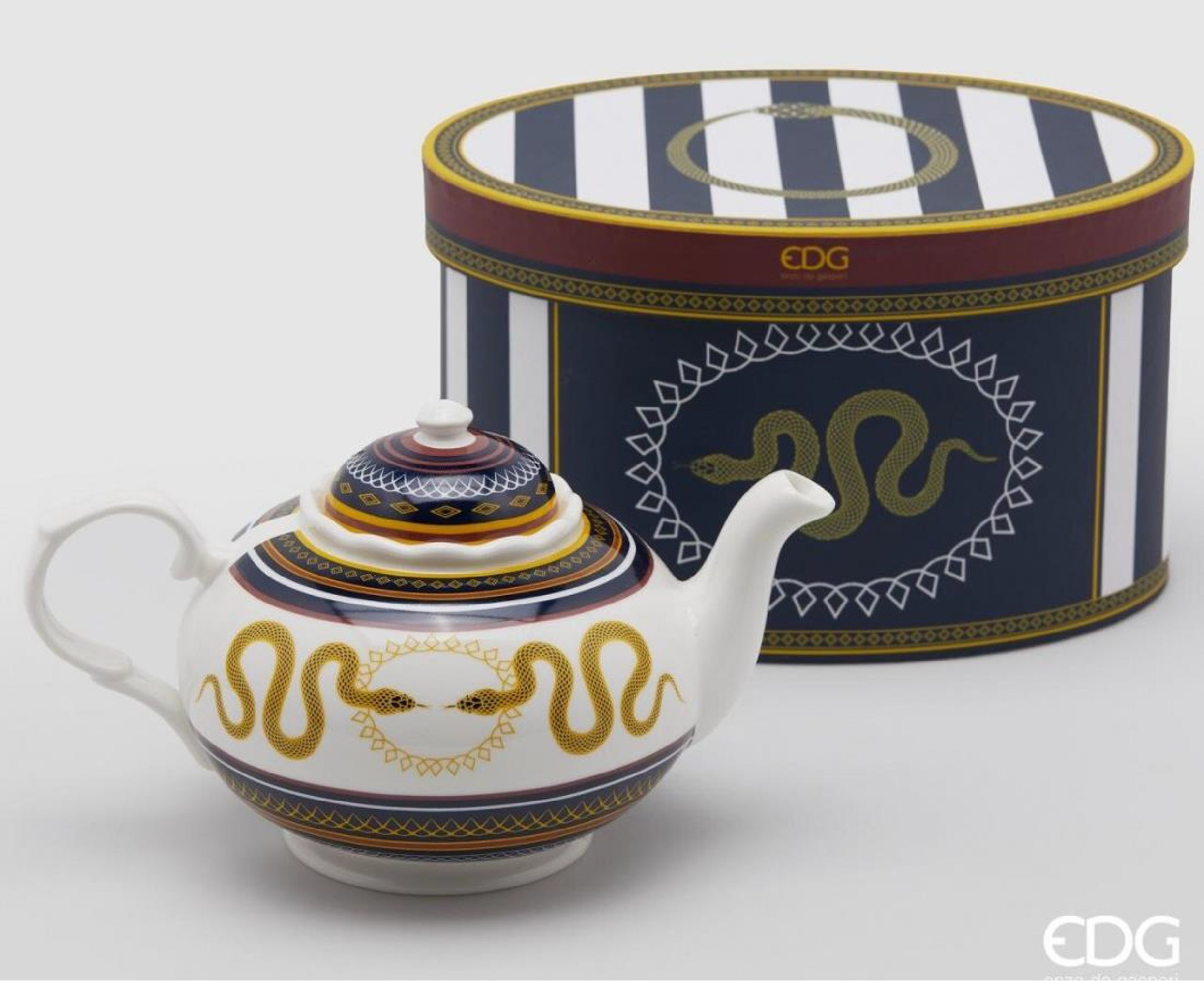 white teapot with serpentine ornament
