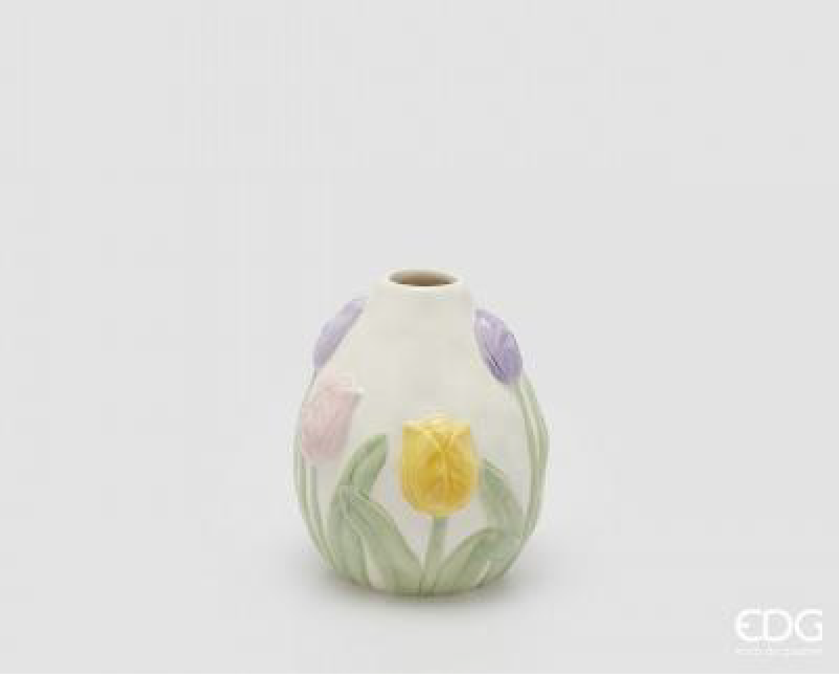 A compact ceramic vase featuring a soft multicolor tulip design in gentle pastel tones. The rounded shape and embossed floral details create a light and seasonal look, bringing a fresh and natural feeling into smaller spaces. Ideal for single stems or small arrangements, it works well as a subtle decorative accent for shelves, tables, or bedside styling. Short description
