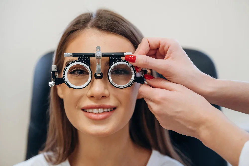 Optometrist adjusting phoropter during eye examination test