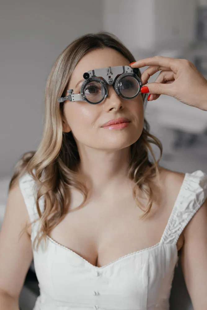 Woman wearing optical phoropter eye exam glasses with magnifying lenses