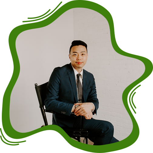 Professional portrait of a male attorney in a dark suit and tie sitting in a chair.