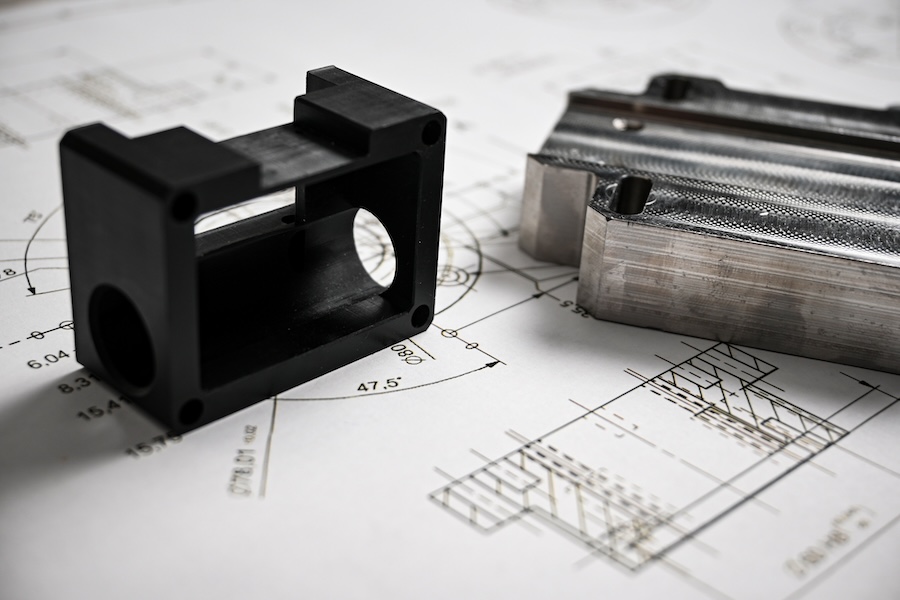 Close-up of engineers evaluating a mechanical component