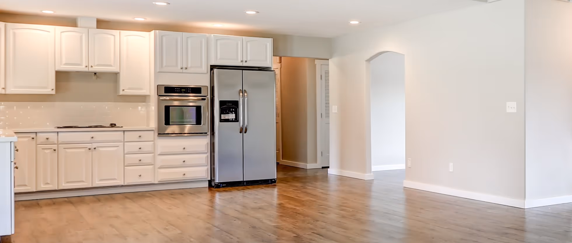 Honey laminate flooring in open kitchen by James River Flooring Richmond VA metro area homes