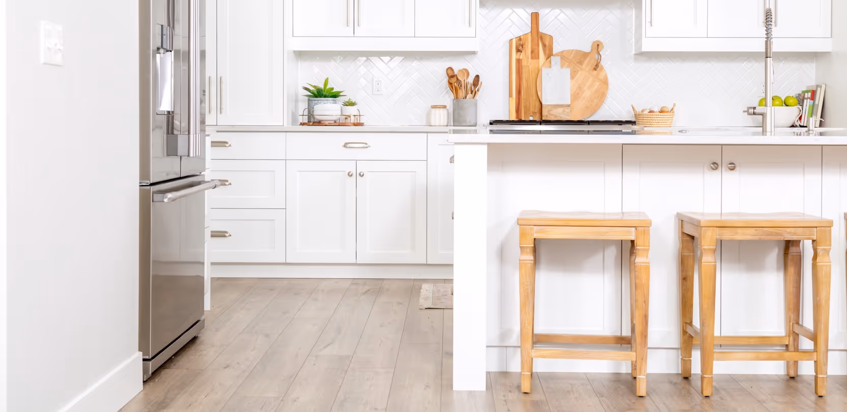 White kitchen with laminate flooring by James River Flooring Richmond VA metro installation experts