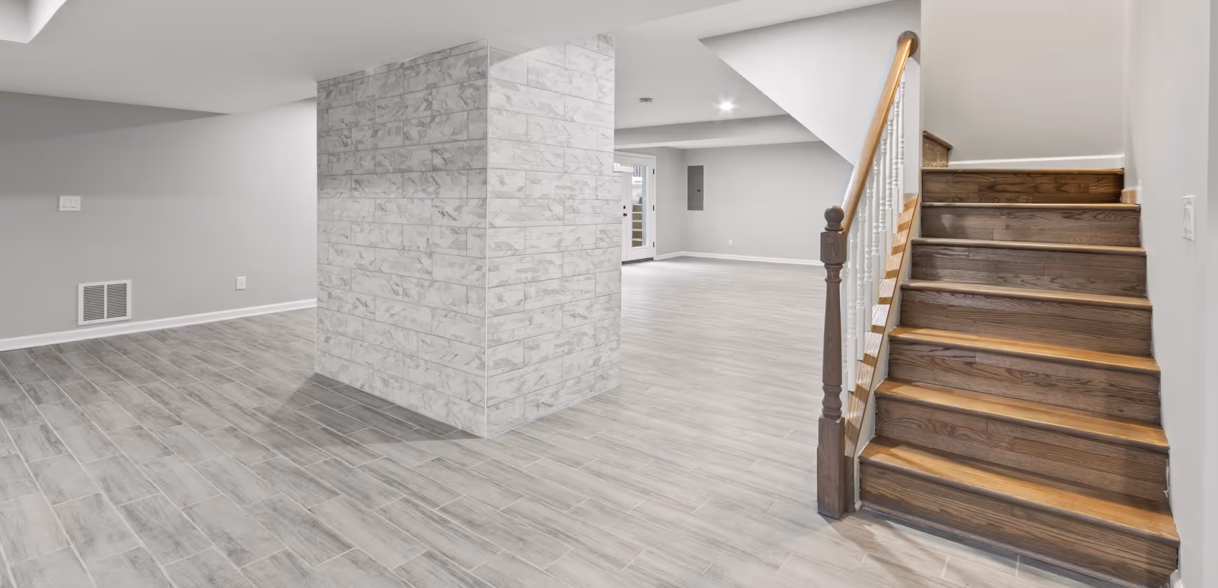 Waterproof basement flooring in Richmond VA home with luxury vinyl plank handling humidity and moisture in finished basement