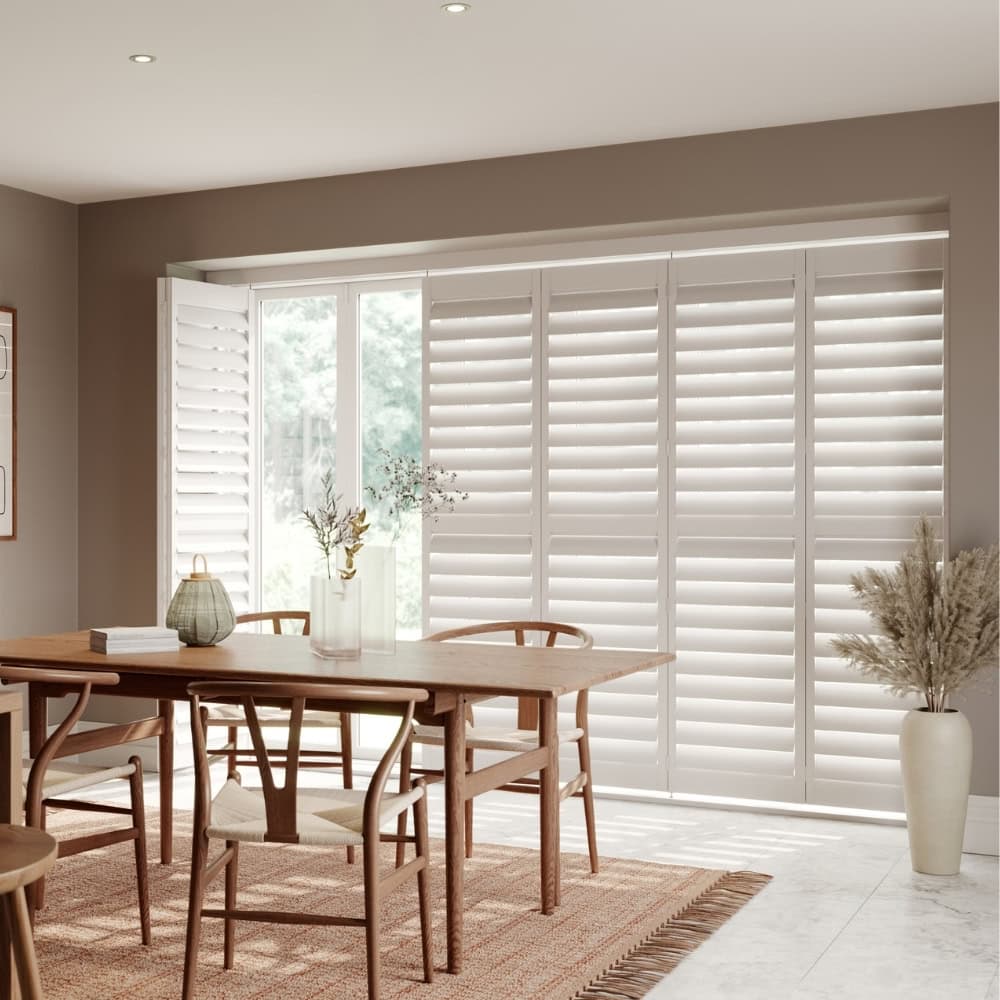 closed white tracked shutters in dining room