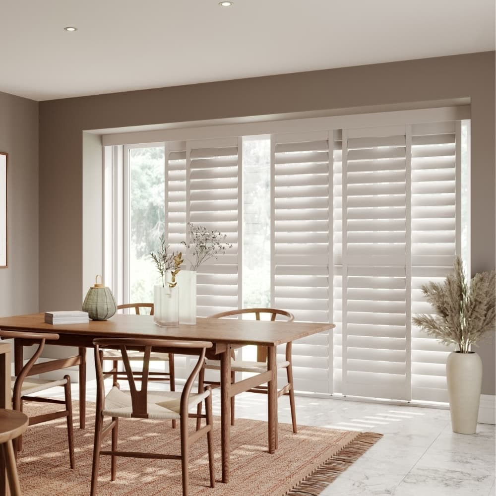 white finished sliding tracked shutters