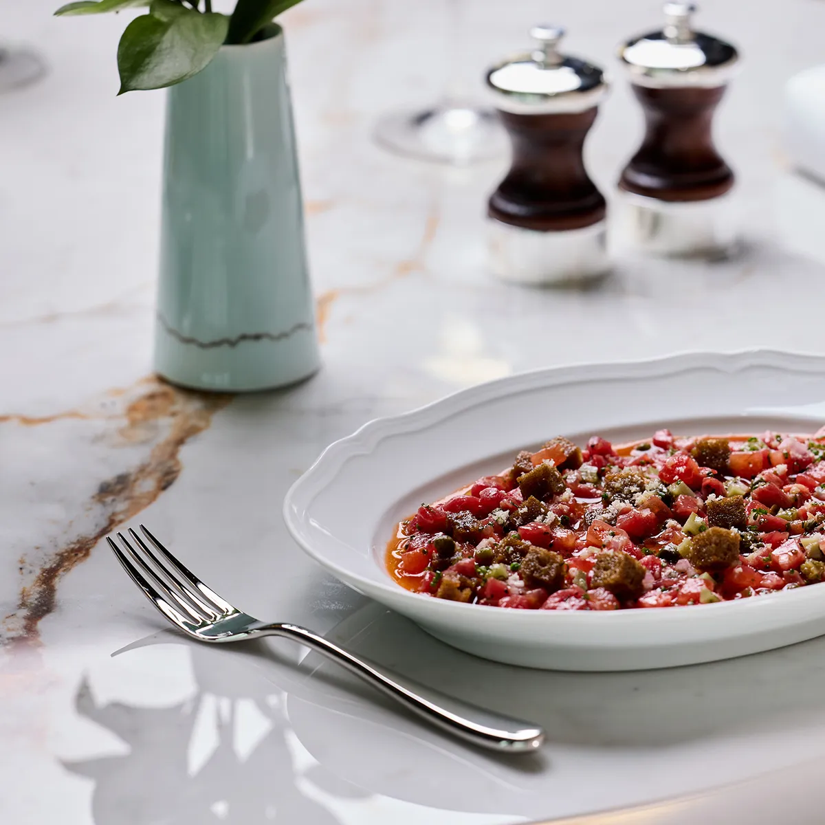 A plate of food on a table in a high-end environment.