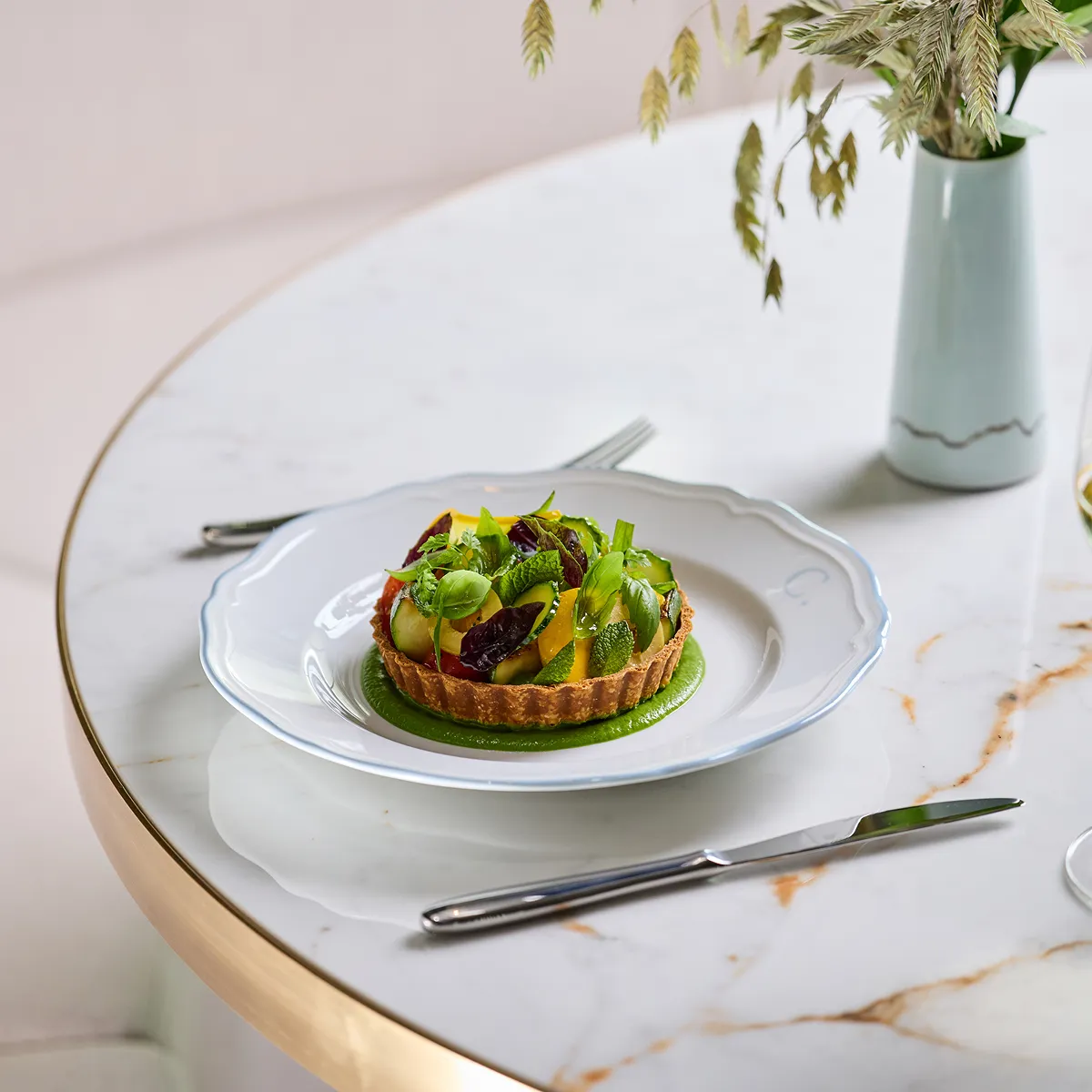 A plate of food on a table in a high-end environment.