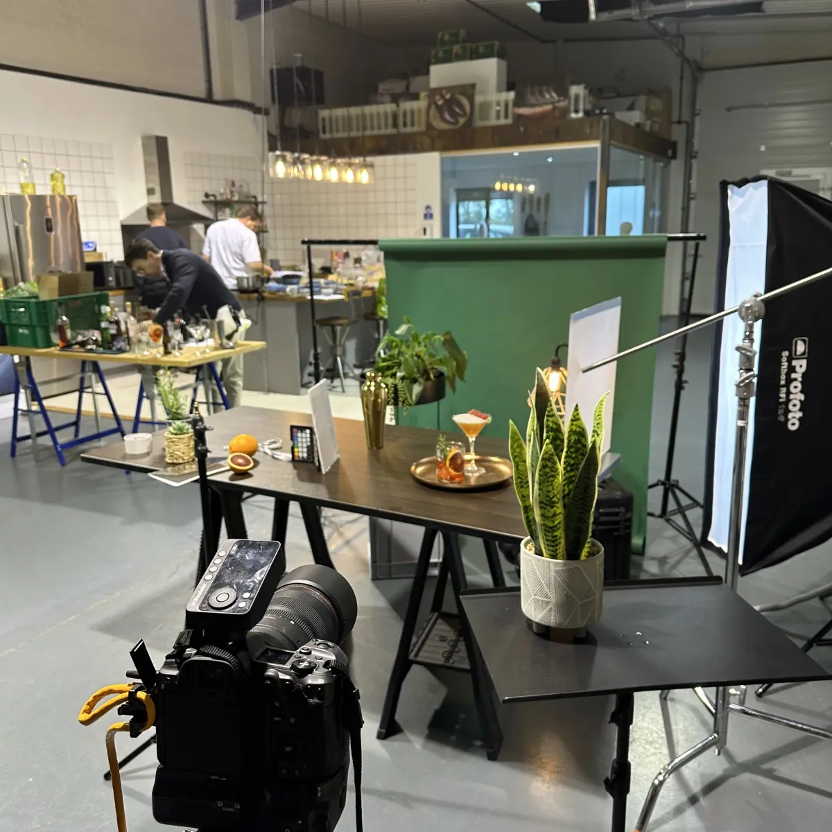 Studio setup for photoshoot with chefs preparing the food in the kitchen.