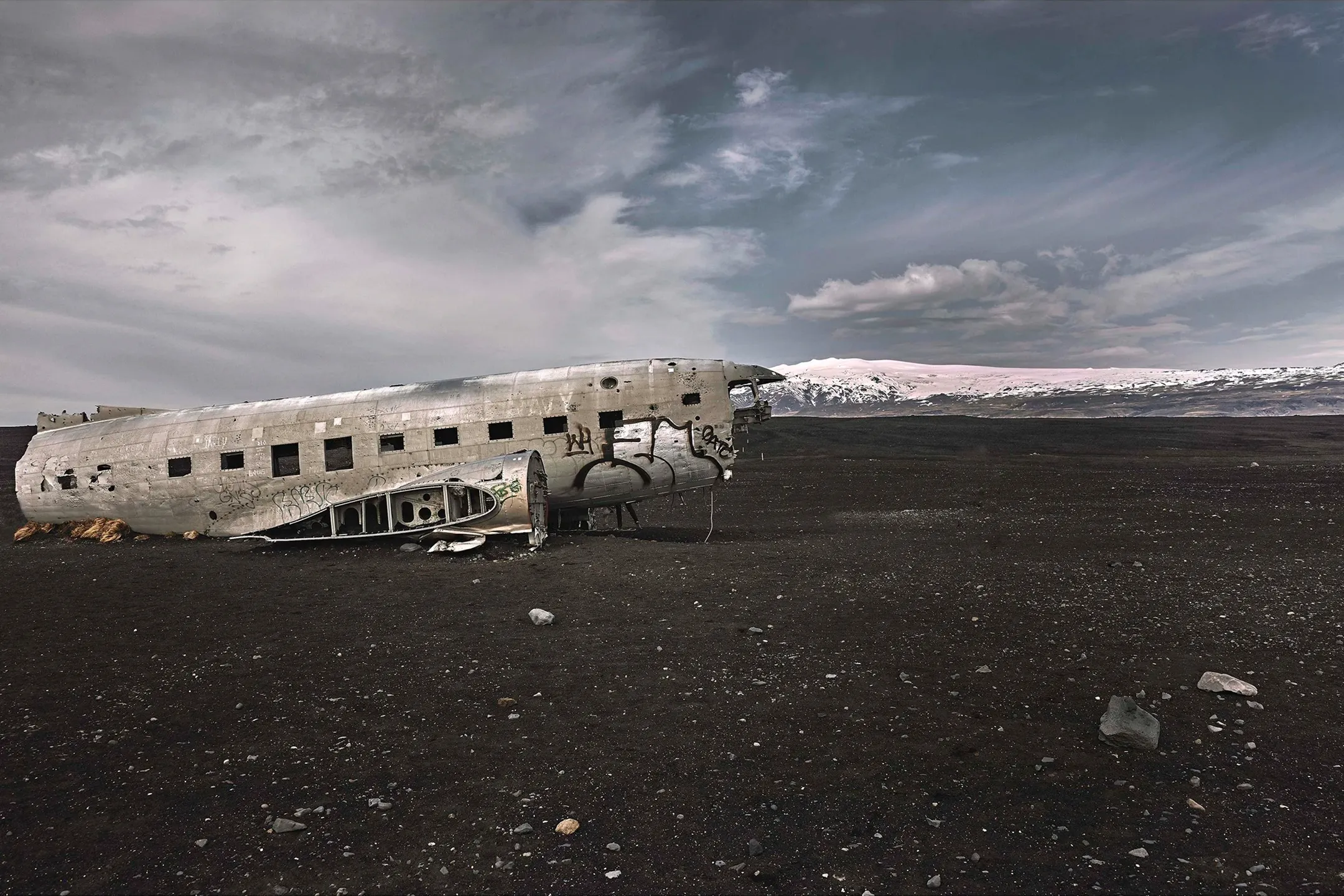 A shell of an old plane with a stunning background.
