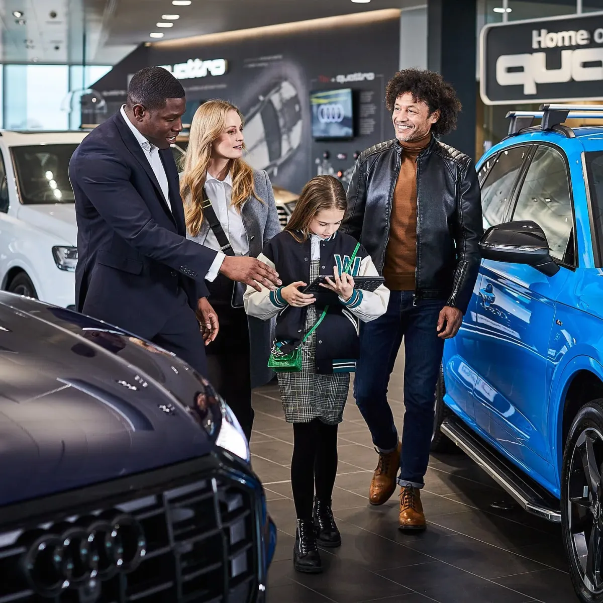Family in a Sytner showroom smiling and looking happy