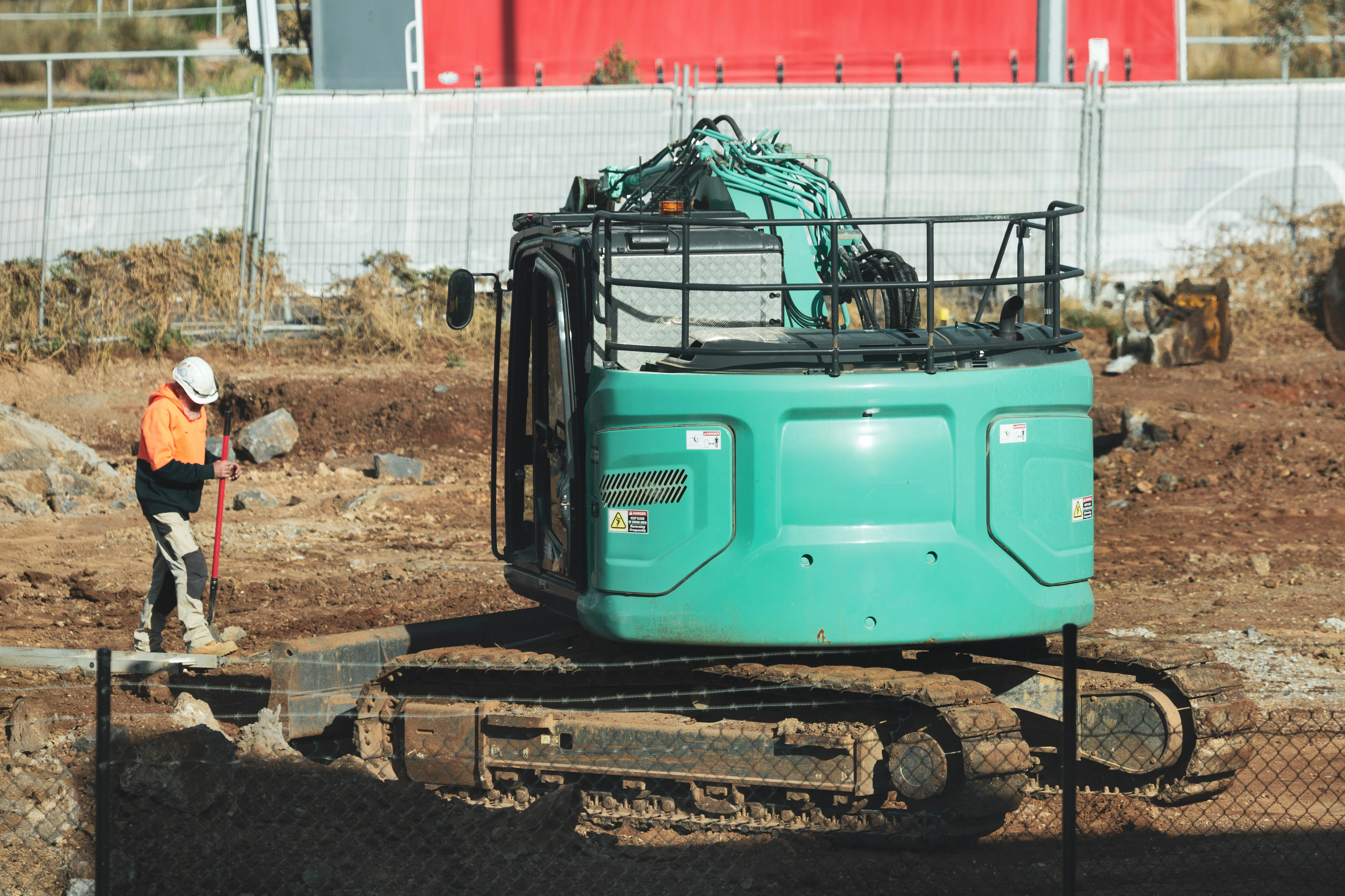 Septic tank contractor operating excavator on job site — heavy equipment insurance coverage in Georgia