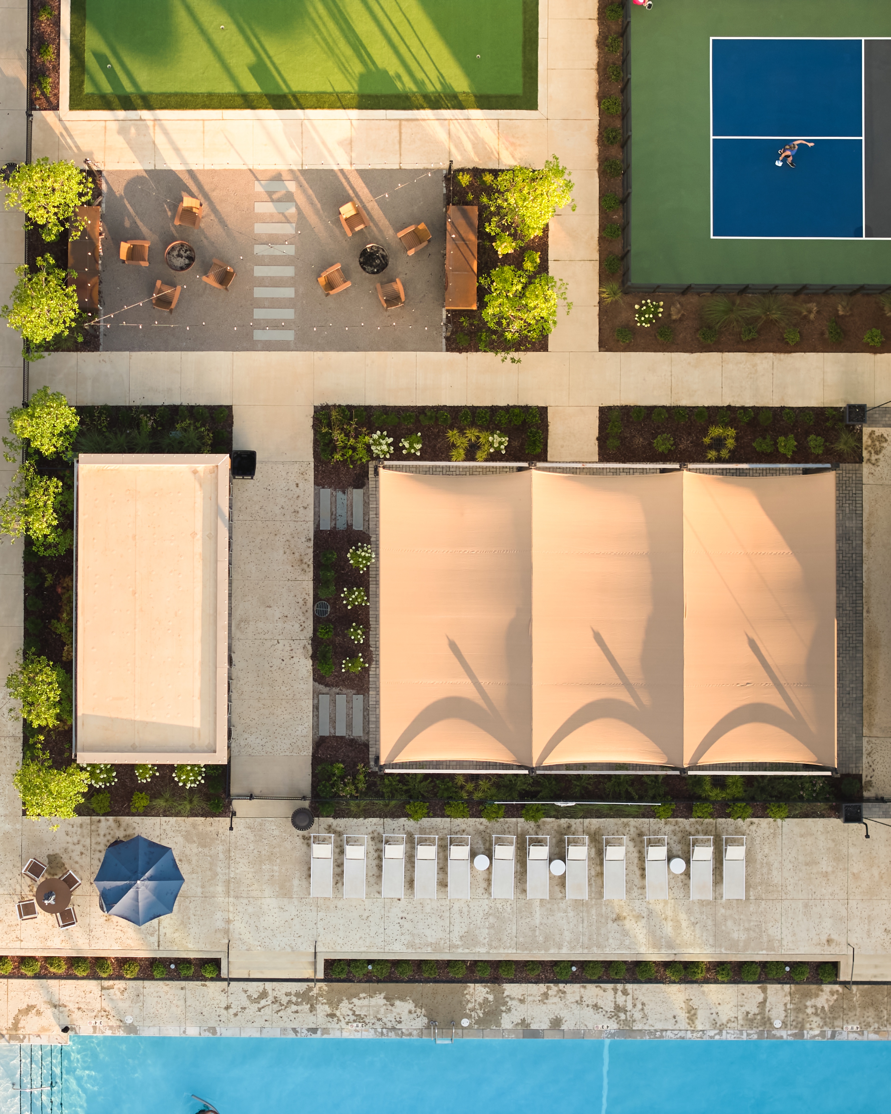 Overhead view of the Everlee Clubhouse shade canopies, lounge terrace and tennis court, photographed by Omar Mohammad Studio