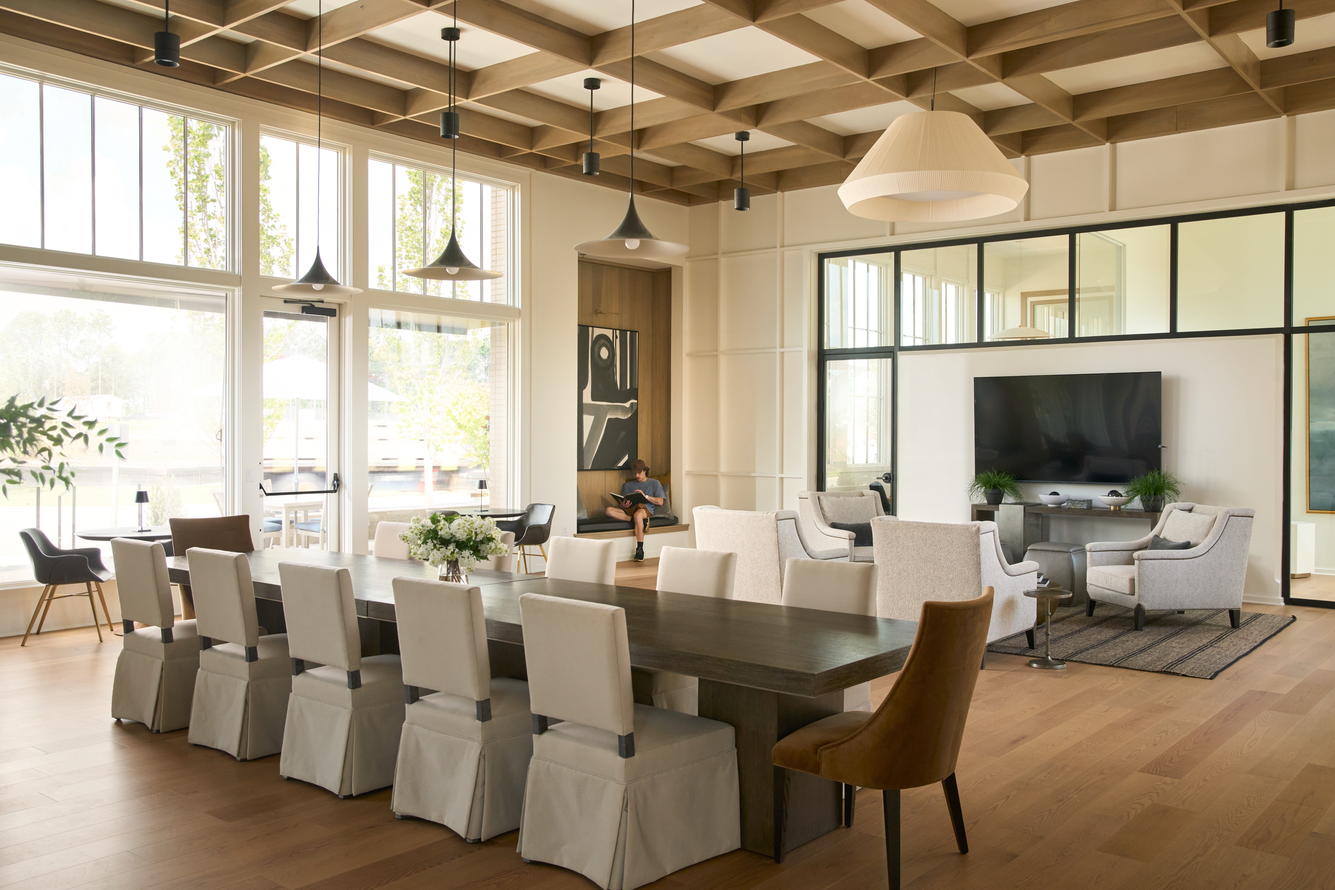 Dining room at the Everlee Clubhouse with a long table under a coffered timber ceiling, photographed by Omar Mohammad Studio