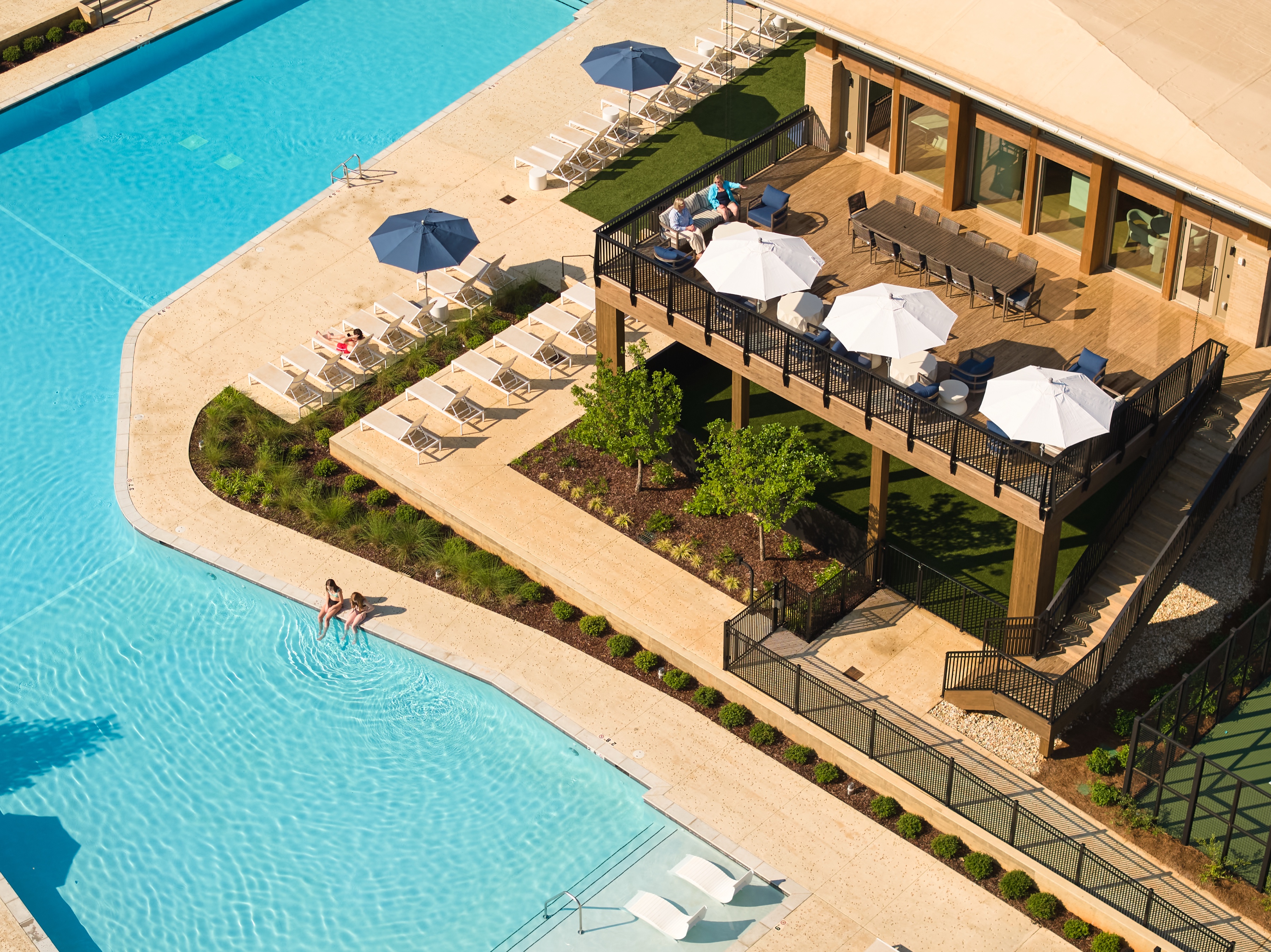 Everlee Clubhouse poolside deck with umbrellas and terrace seating seen from above, architectural photography by Omar Mohammad Studio