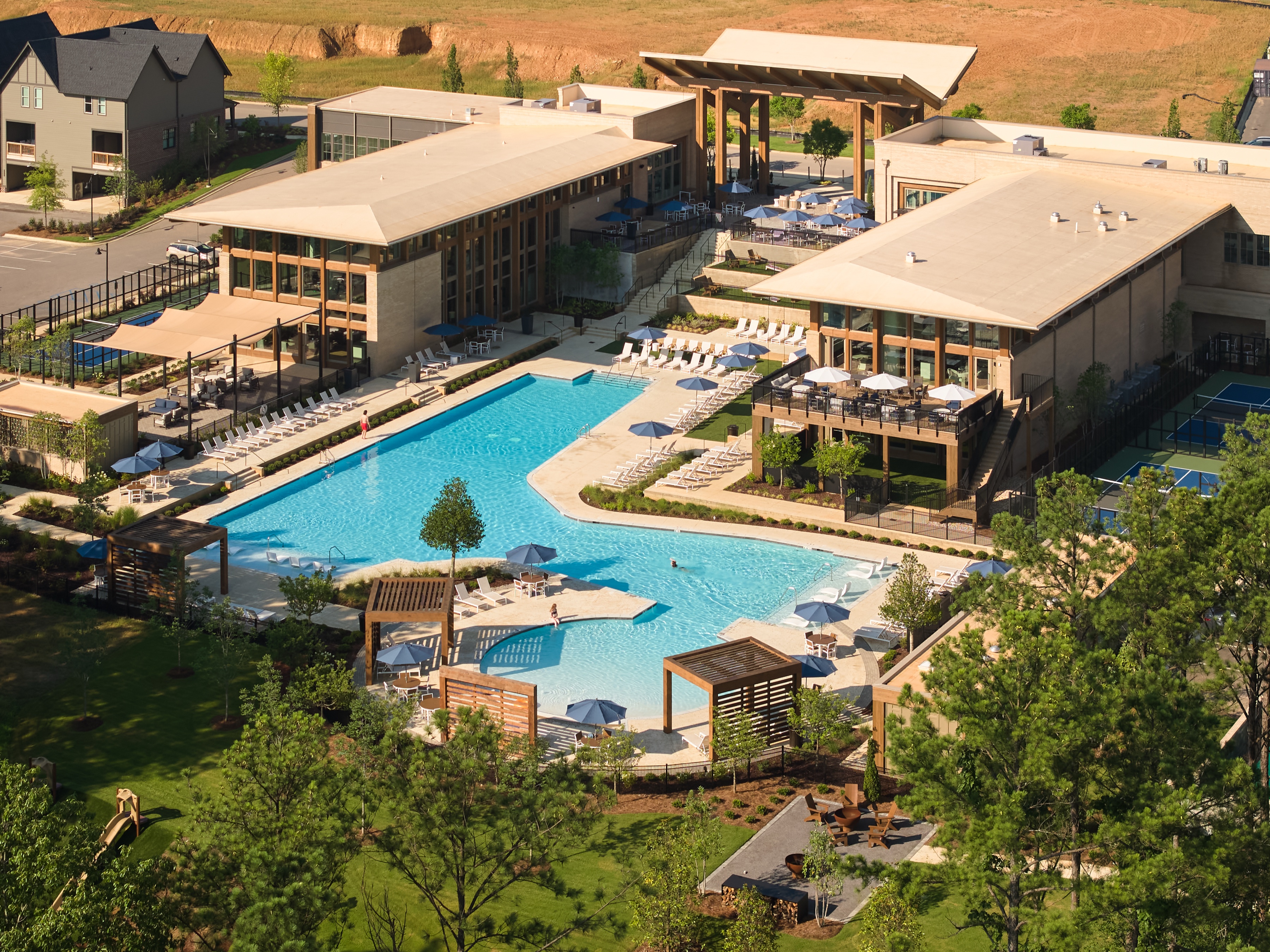 Aerial view of the full Everlee Clubhouse amenity campus and resort pool by Nequette, photographed by Omar Mohammad Studio