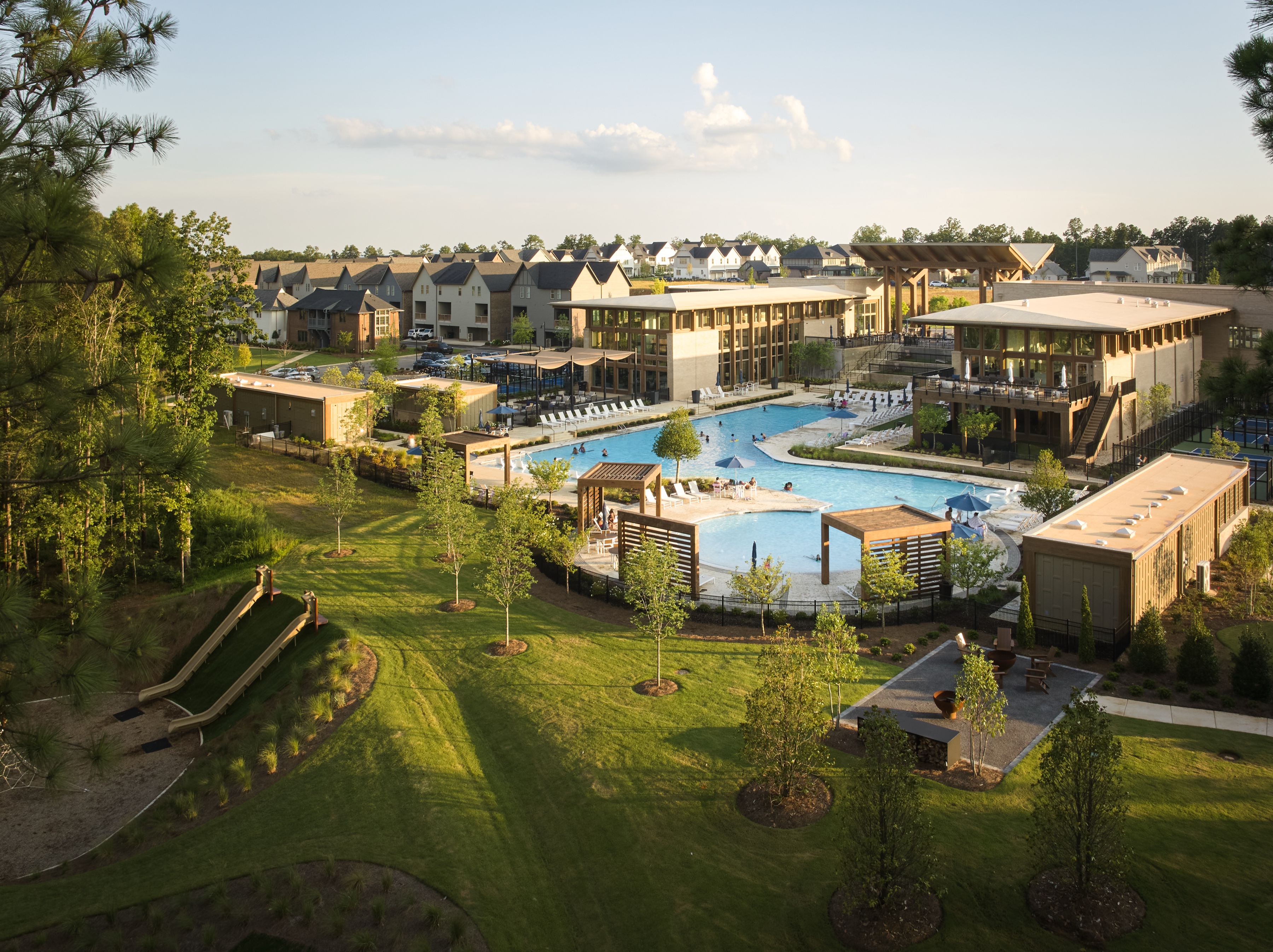 Elevated view of the Everlee Clubhouse pool, lawn and surrounding homes by Nequette, architectural photography by Omar Mohammad Studio