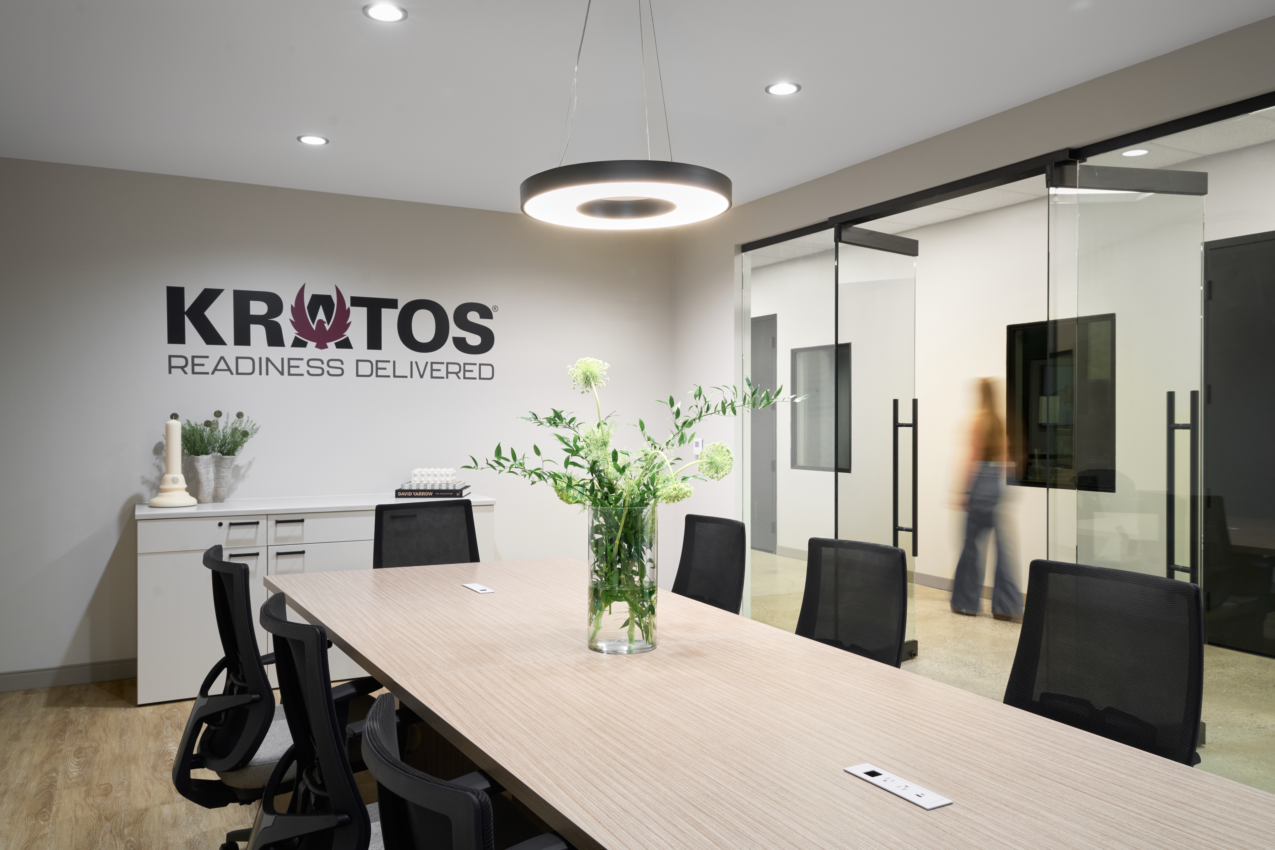 Kratos boardroom with branded wall and pendant lighting, workplace photography by Omar Mohammad Studio