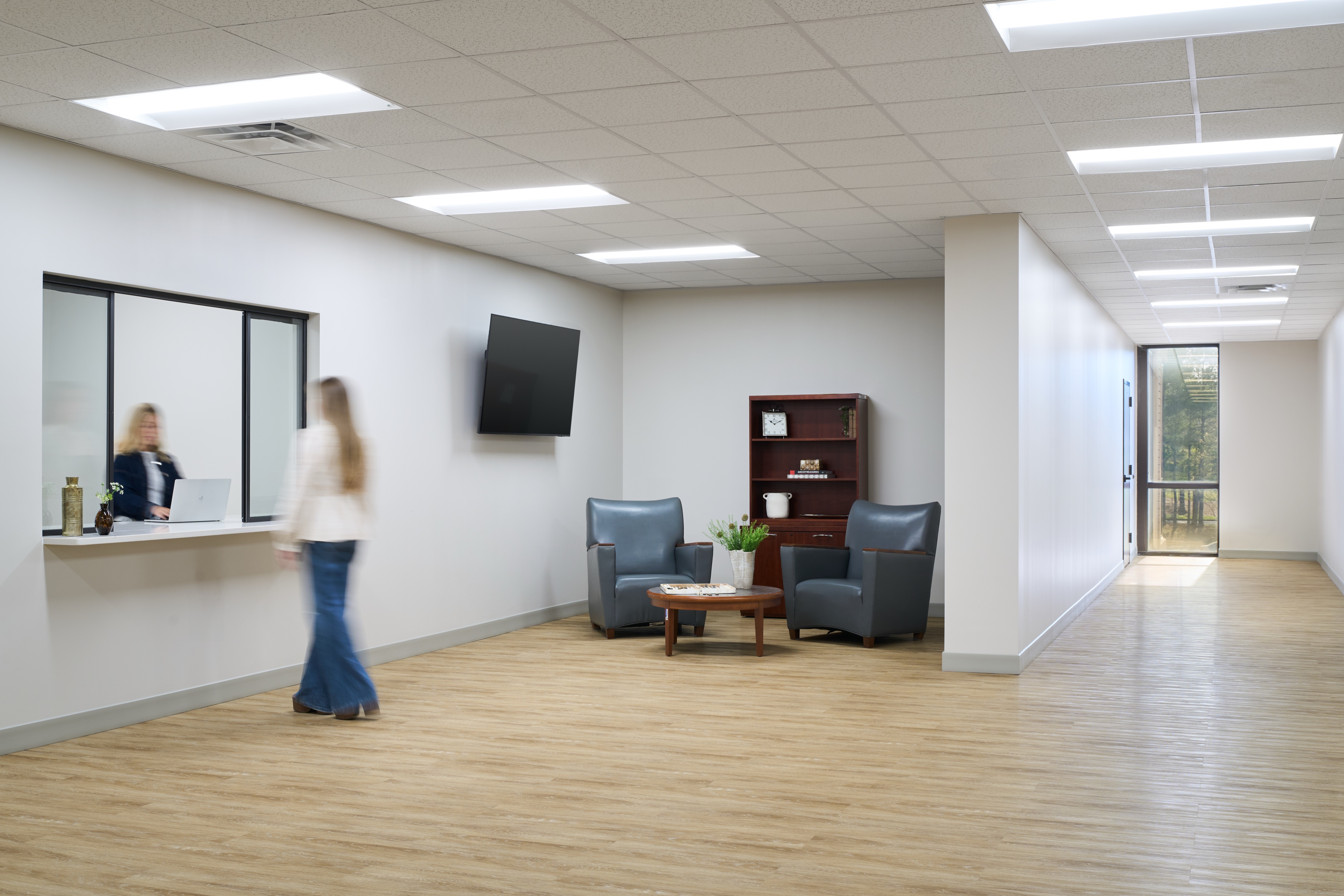 Reception lobby with check in window, wall mounted display and waiting seating, workplace photography by Omar Mohammad Studio