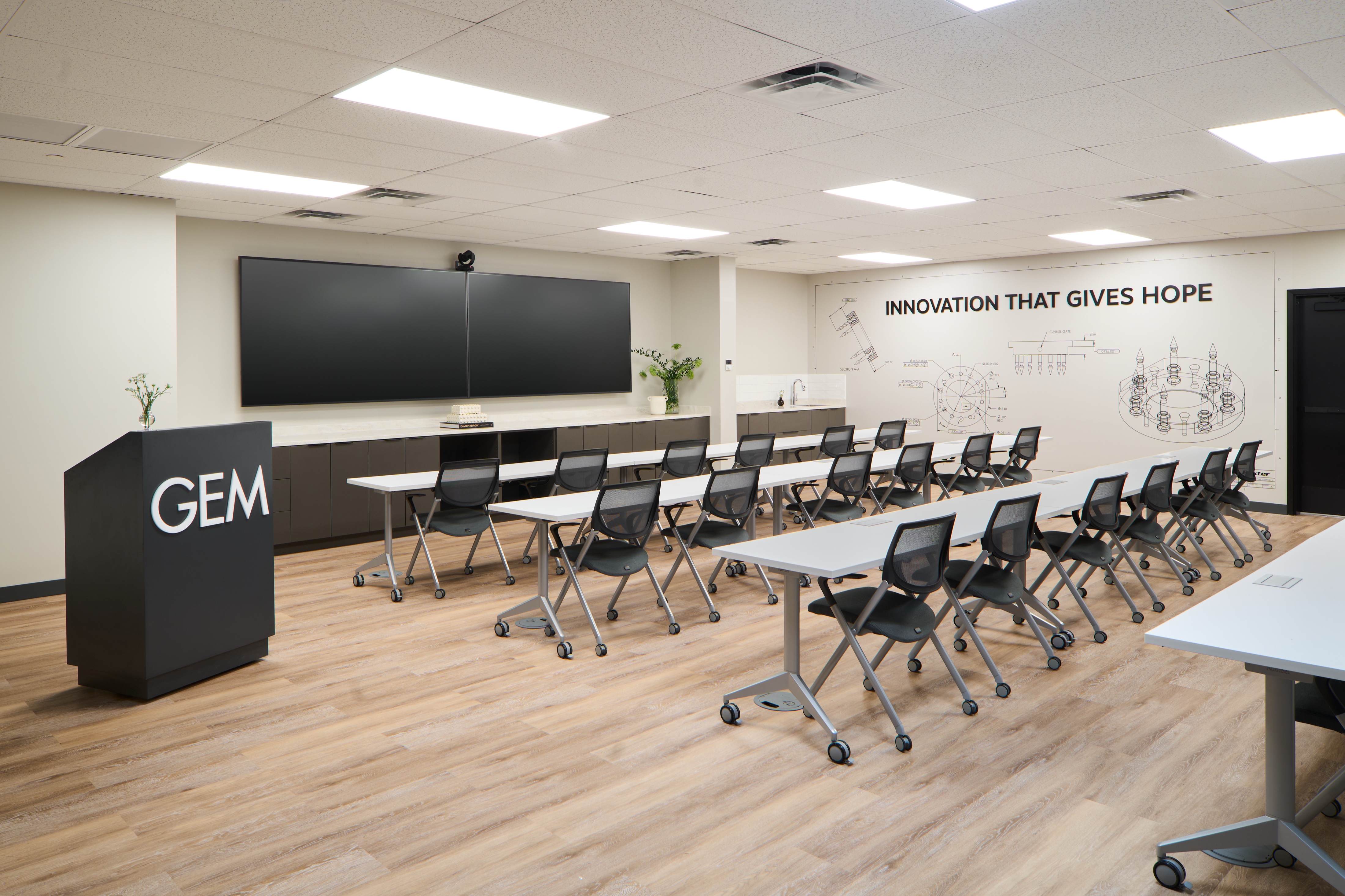 GEM training room with lectern, tiered seating and dual displays, workplace photography by Omar Mohammad Studio