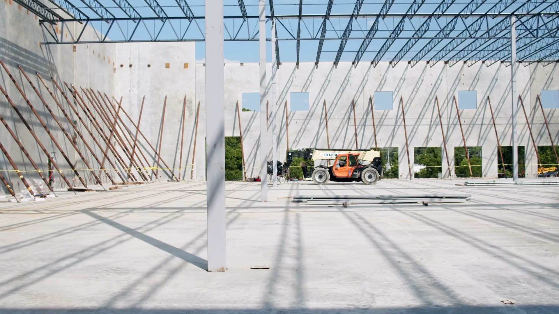 Video frame of crews on lifts inside the Hermitage steel frame