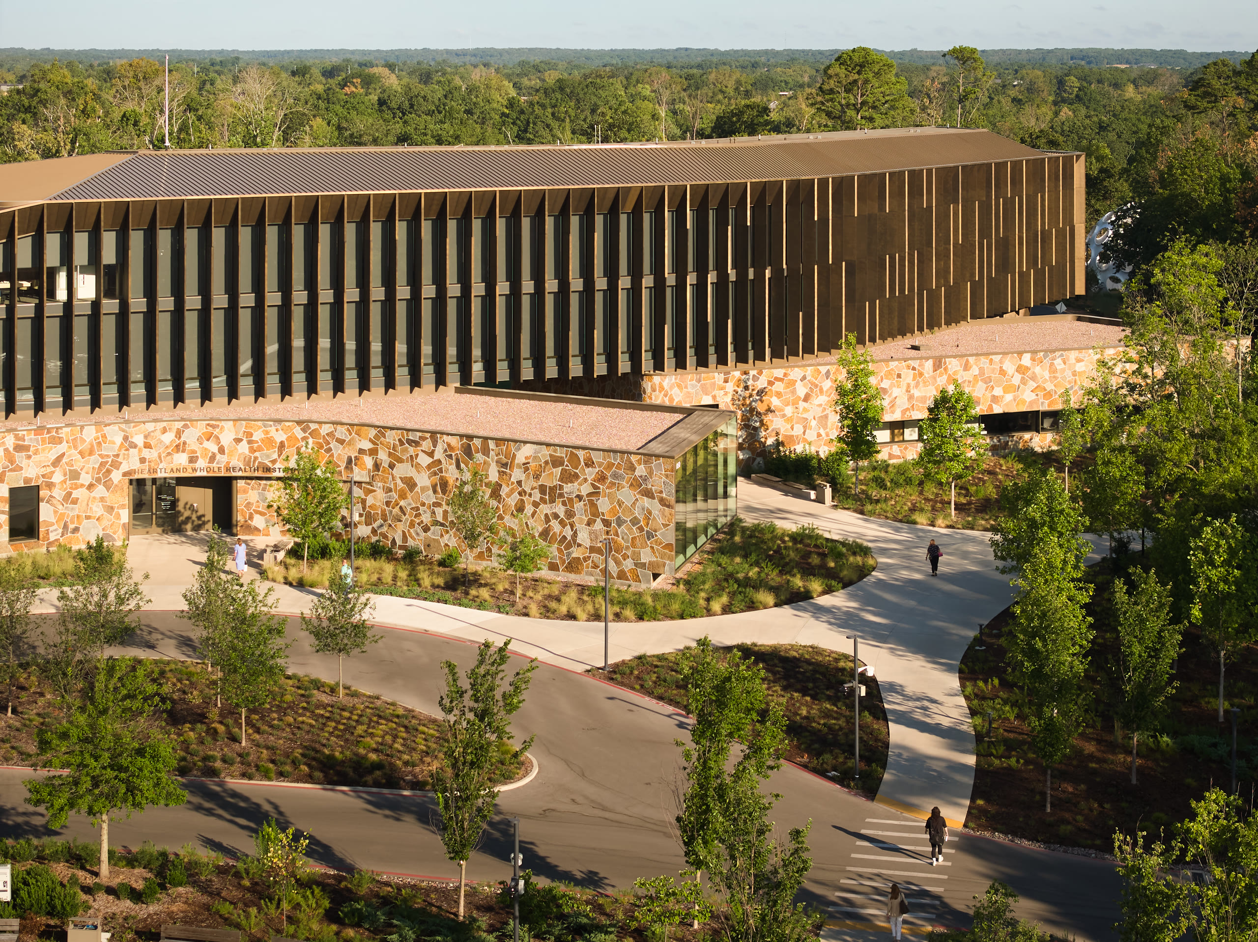 Elevated view of the timber-screened building and stone walls at Heartland Whole Health Institute, architectural photography by Omar Mohammad Studio