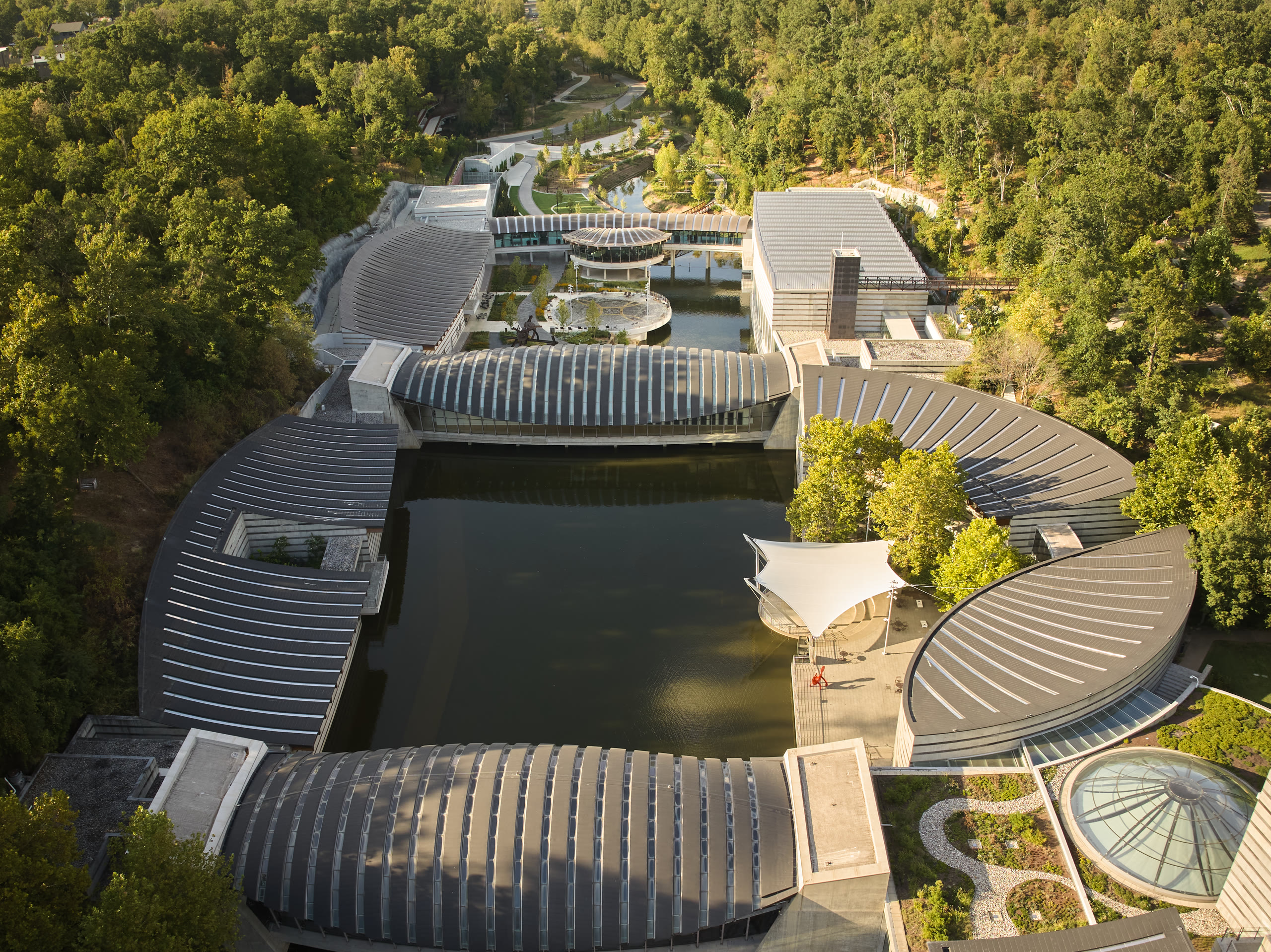 Aerial view of the Crystal Bridges Museum of American Art pavilions around the ponds, architectural photography by Omar Mohammad Studio