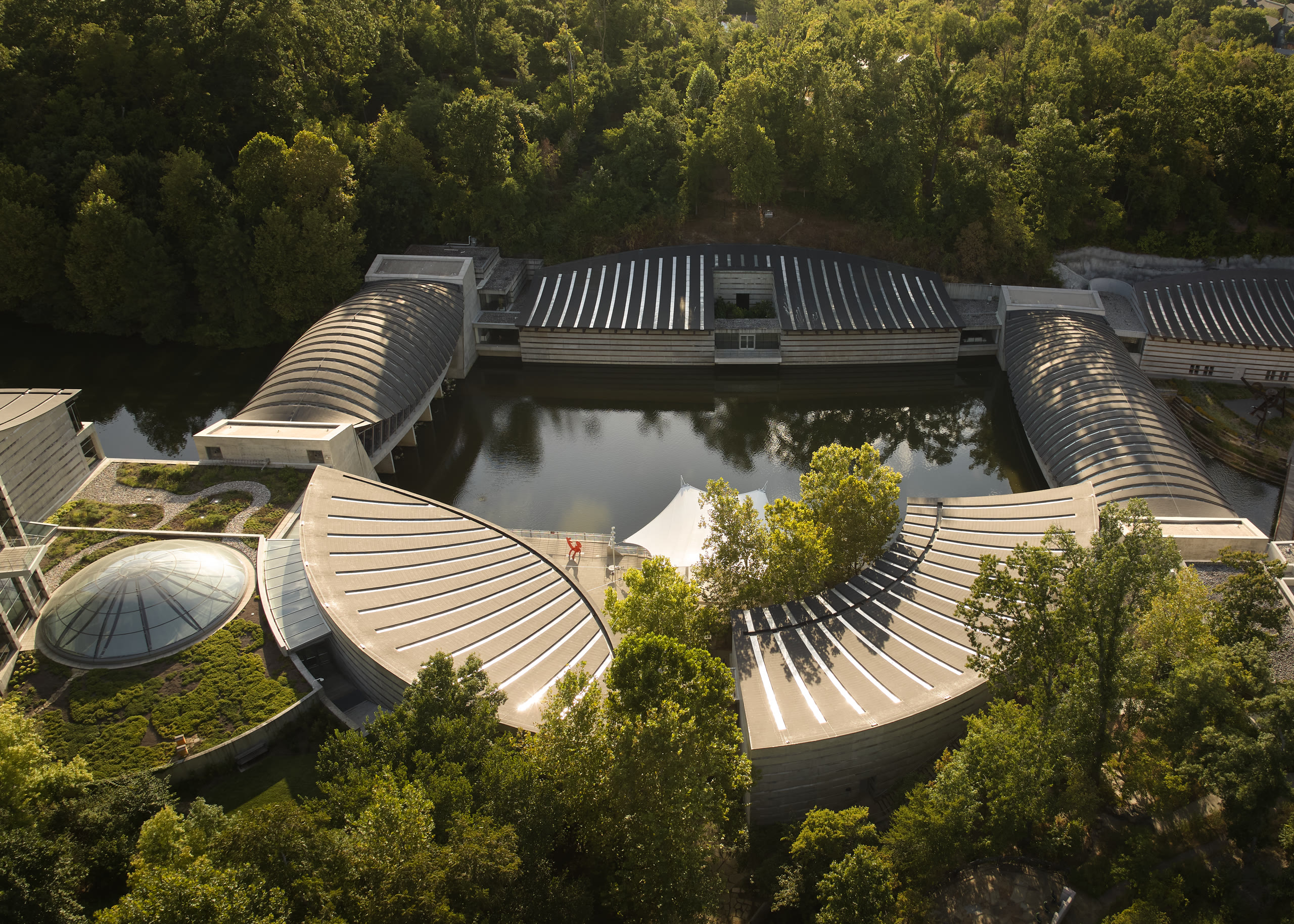 Aerial view of the curved roofs and ponds at Crystal Bridges Museum of American Art, architectural photography by Omar Mohammad Studio