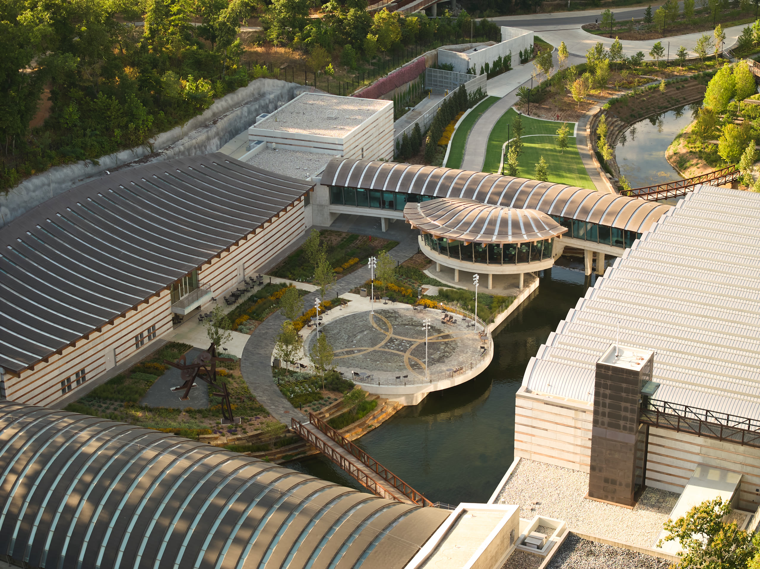 Aerial view of the Crystal Bridges galleries and courtyards in the wooded ravine, architectural photography by Omar Mohammad Studio
