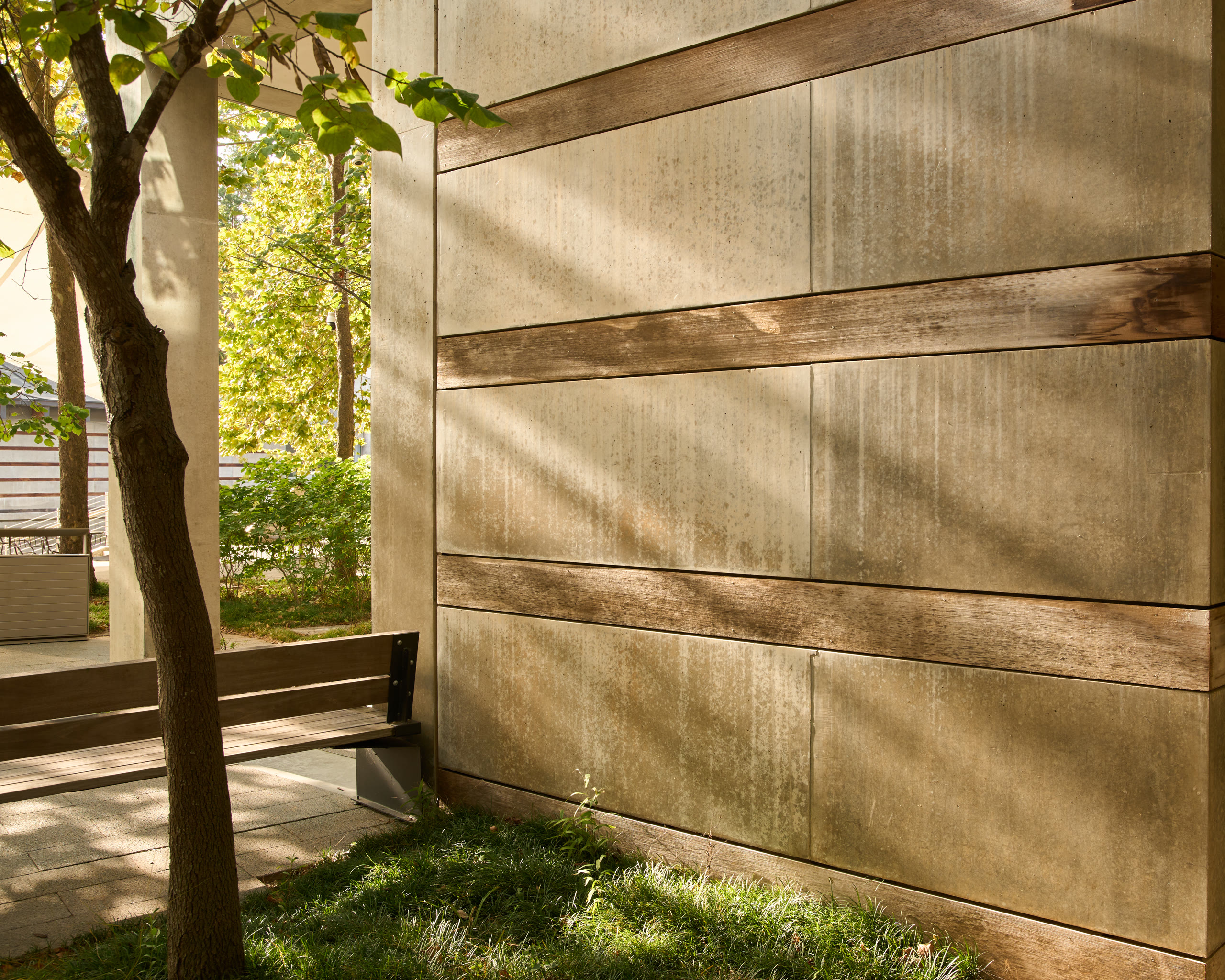 Light through the trees on a banded concrete wall at Crystal Bridges Museum of American Art, architectural photography by Omar Mohammad Studio