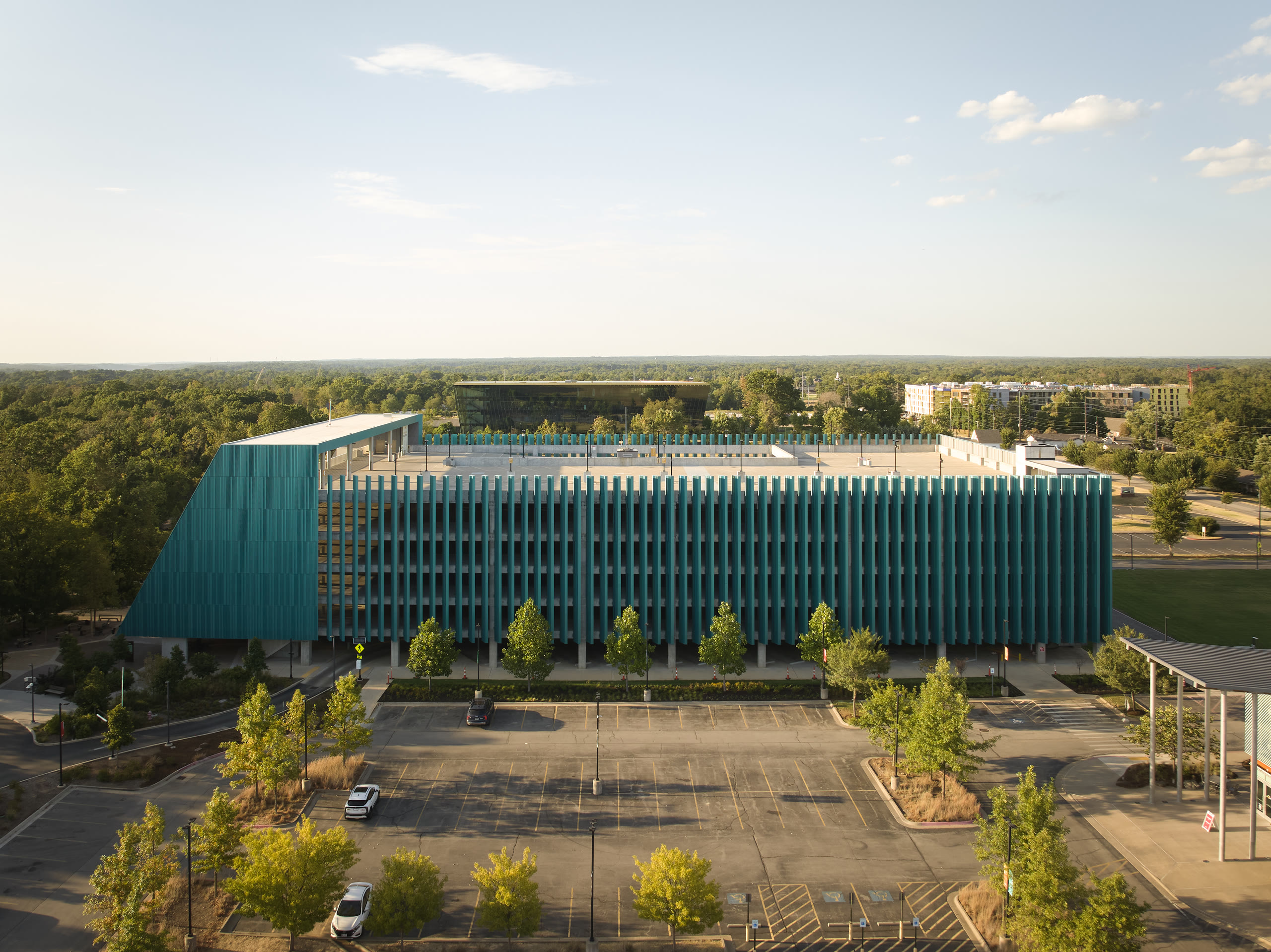 The Crystal Bridges parking deck in Bentonville, Arkansas, wrapped in tall teal fins. Architectural photography by Omar Mohammad Studio.