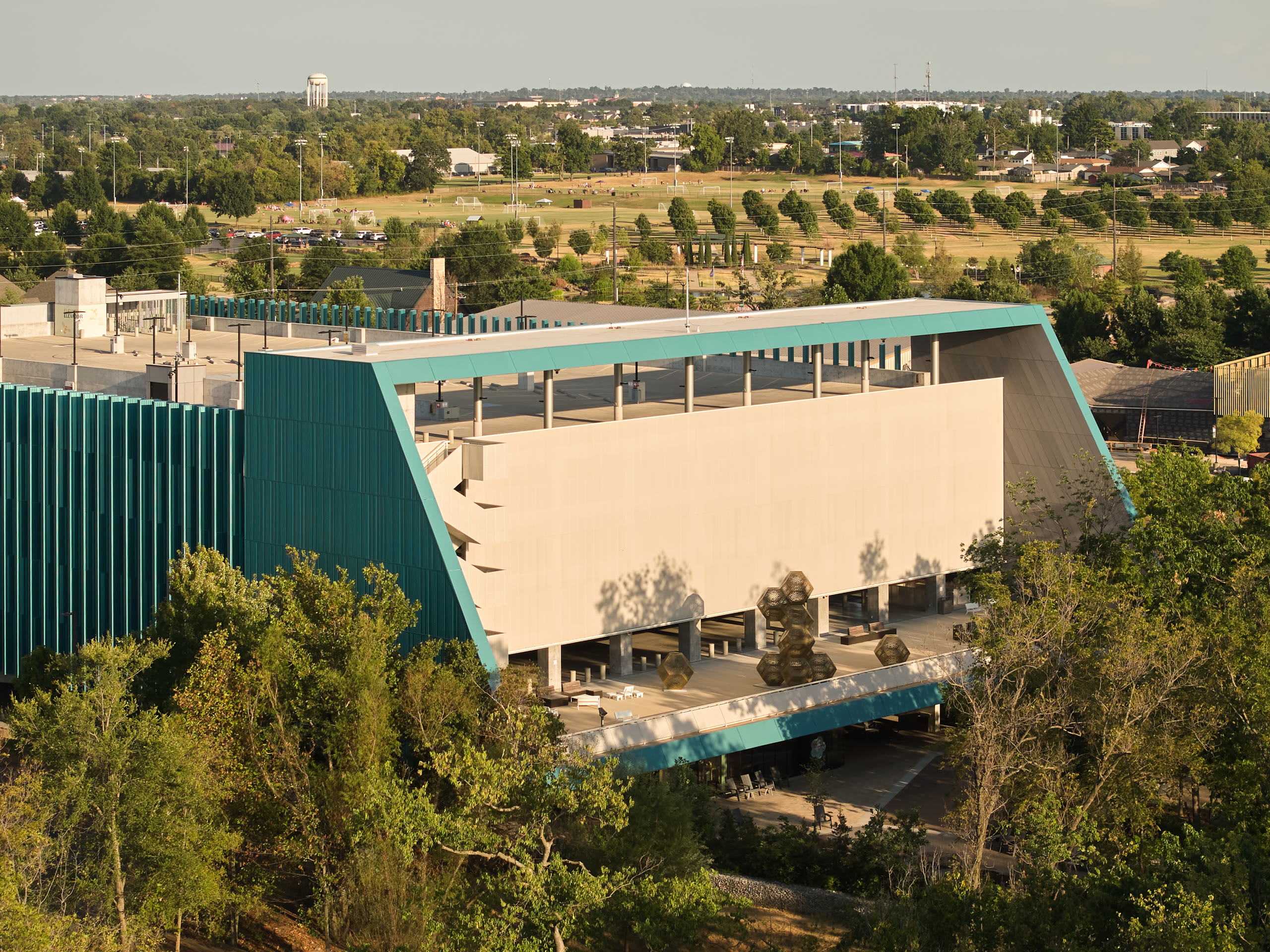 Aerial view of the Crystal Bridges parking deck rooftop and sloped teal edge, architectural photography by Omar Mohammad Studio
