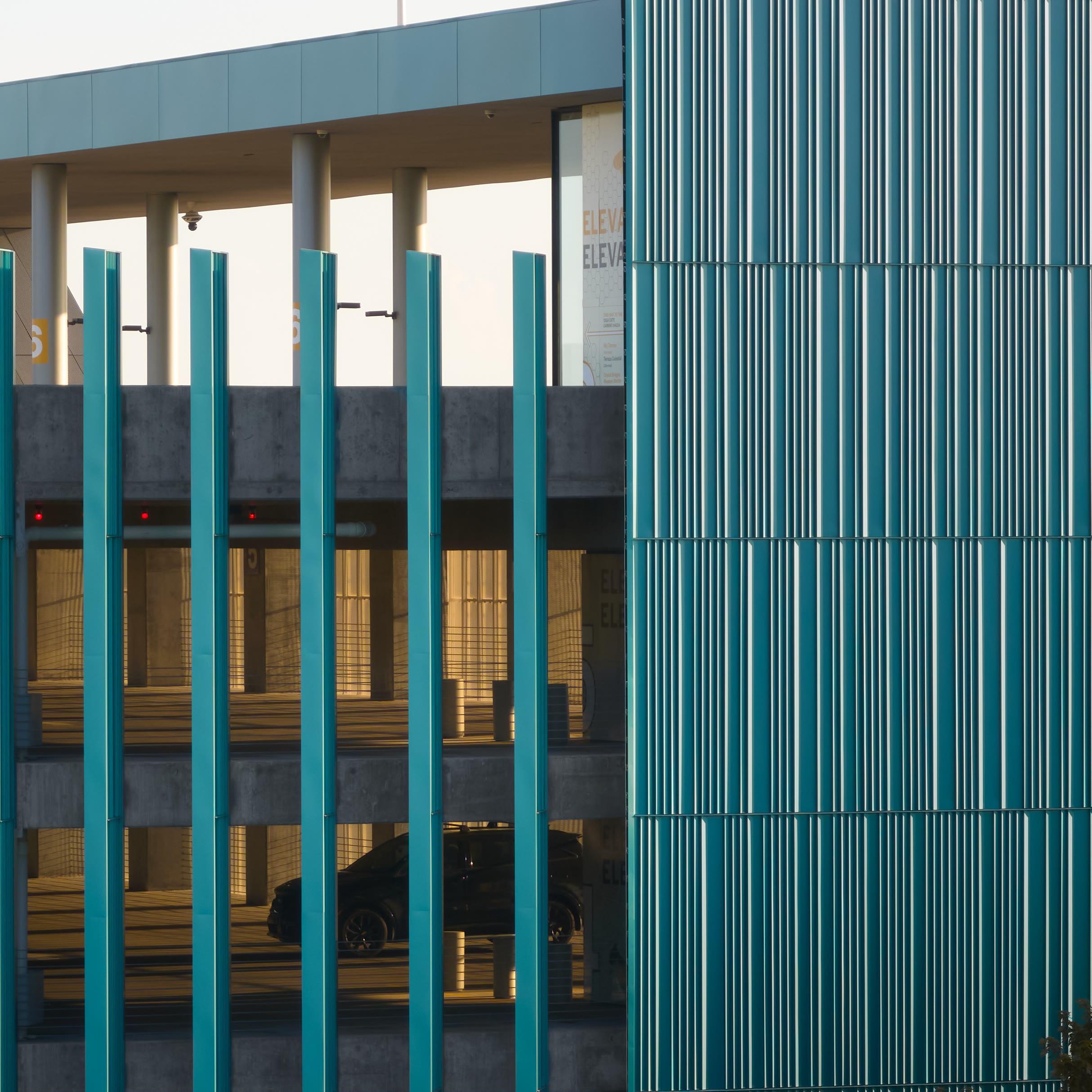 Close view of the vertical teal fins on the Crystal Bridges parking deck, architectural photography by Omar Mohammad Studio