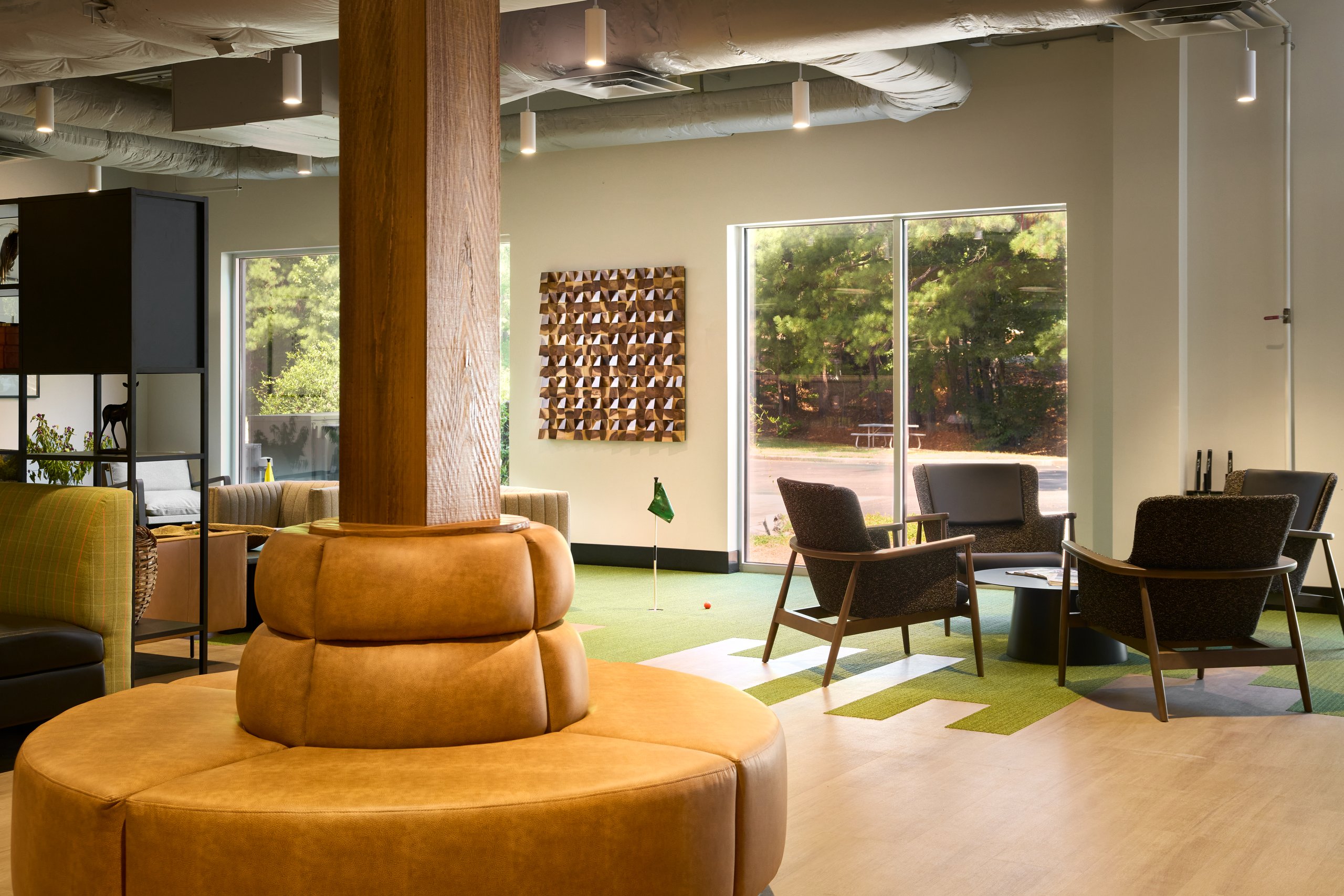 Moultrie's office off Highway 280: a lounge under exposed ceilings, glass offices, a training room and a moss wall. Photography by Omar Mohammad Studio.
