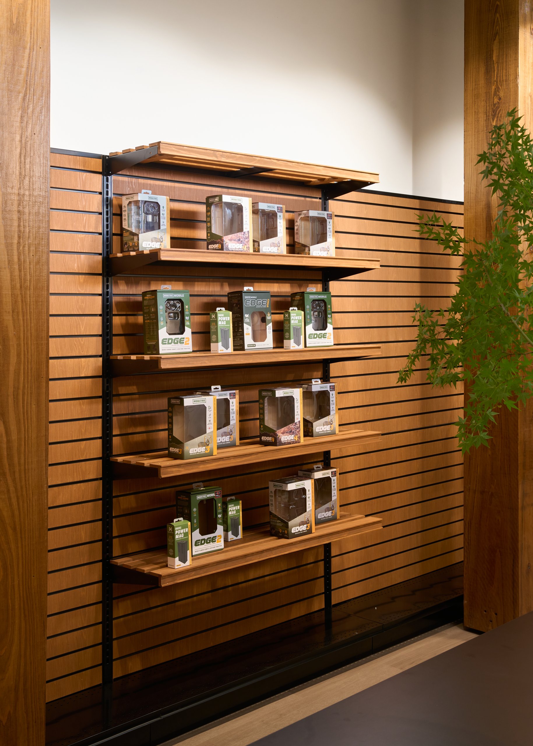 Wood slat display wall with product shelving at the Moultrie office