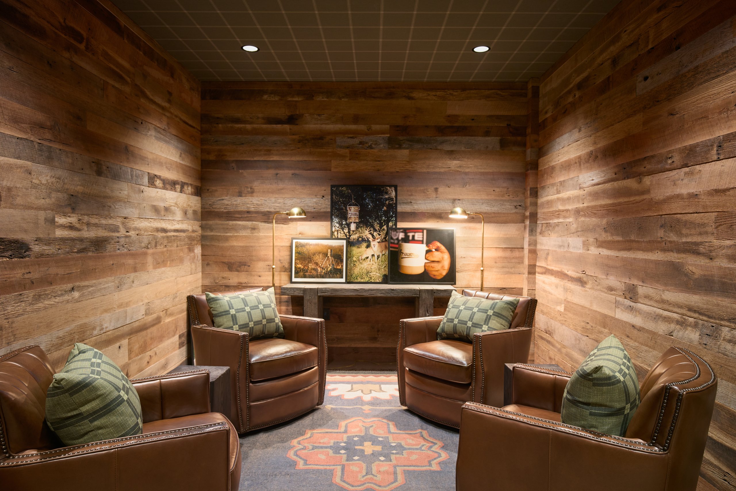 Lounge with reclaimed wood walls and leather chairs at the Moultrie office