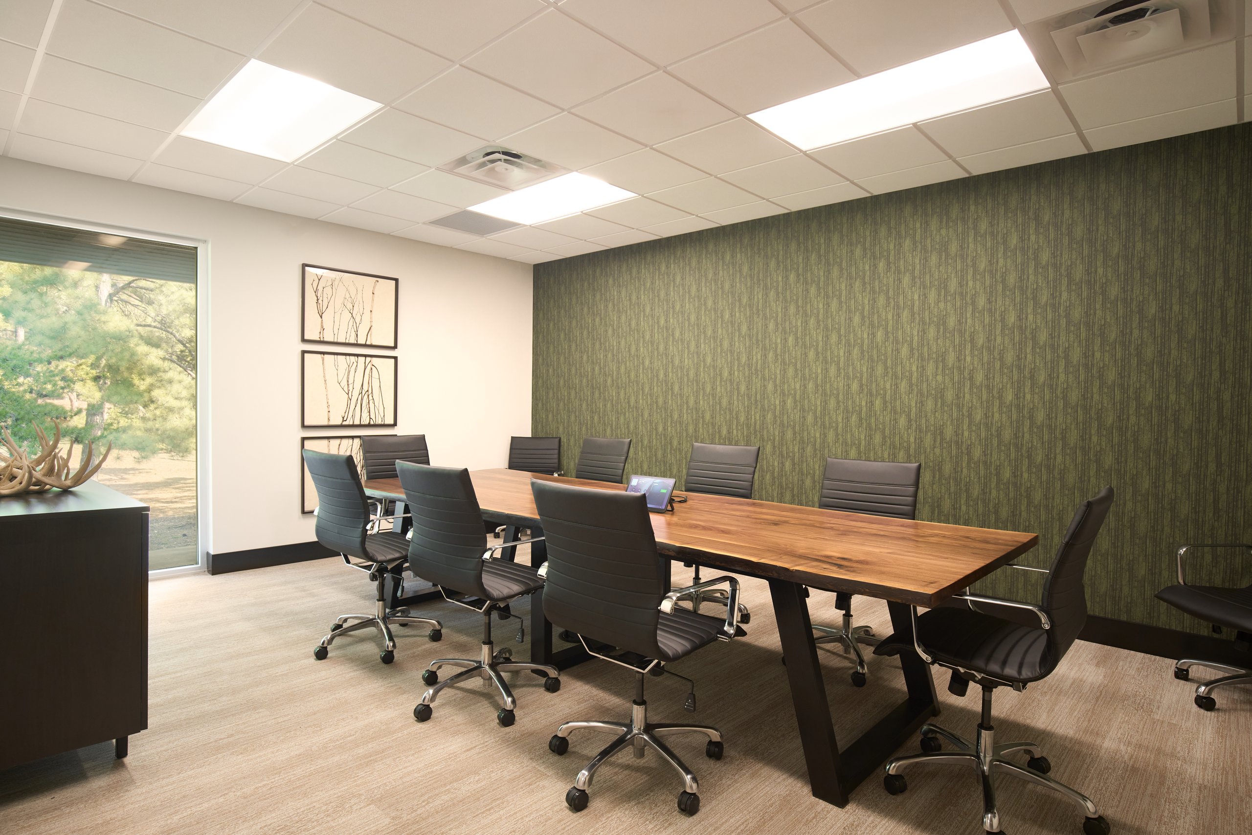 Conference room with a green feature wall at the Moultrie office