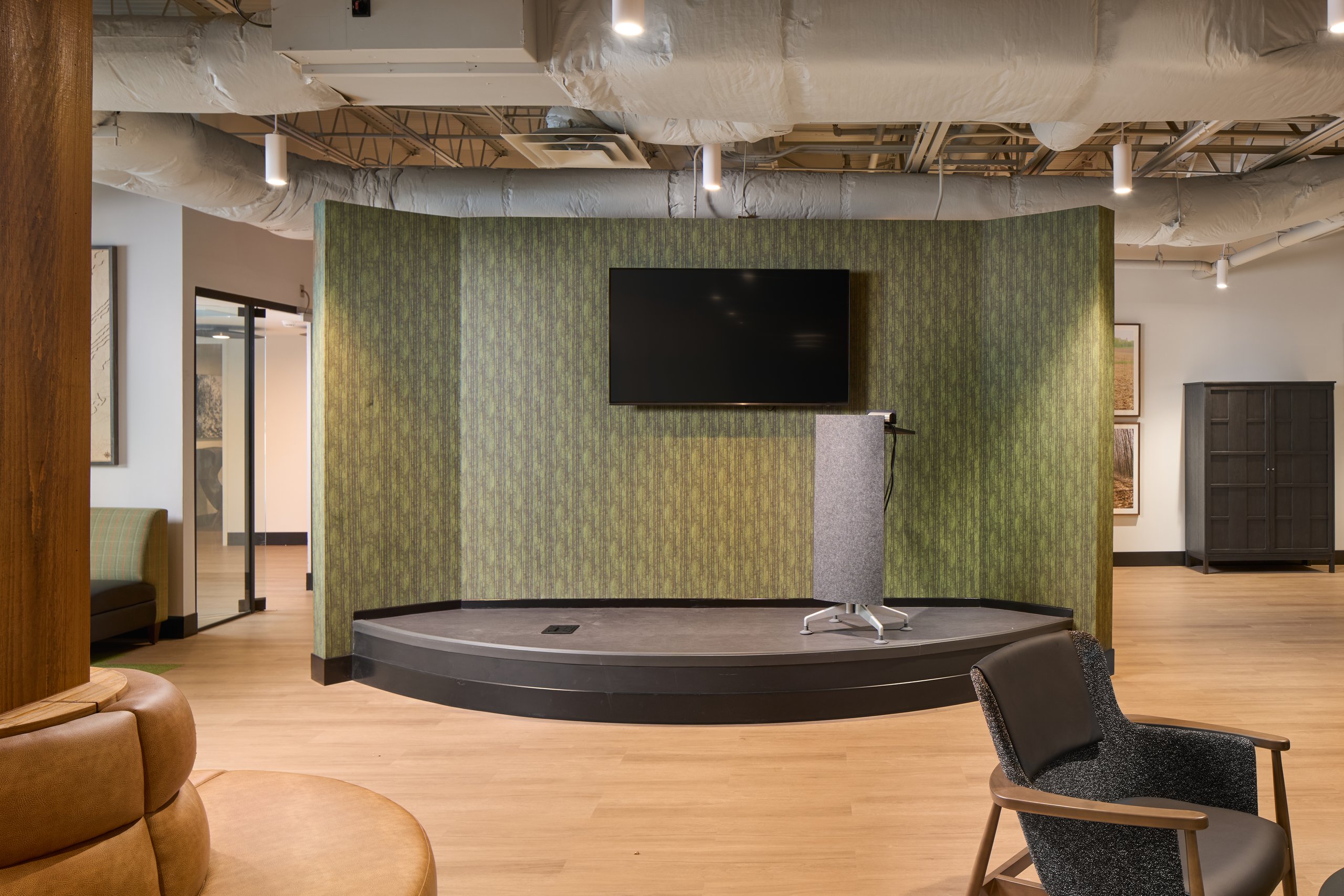Presentation stage with a green backdrop at the Moultrie office