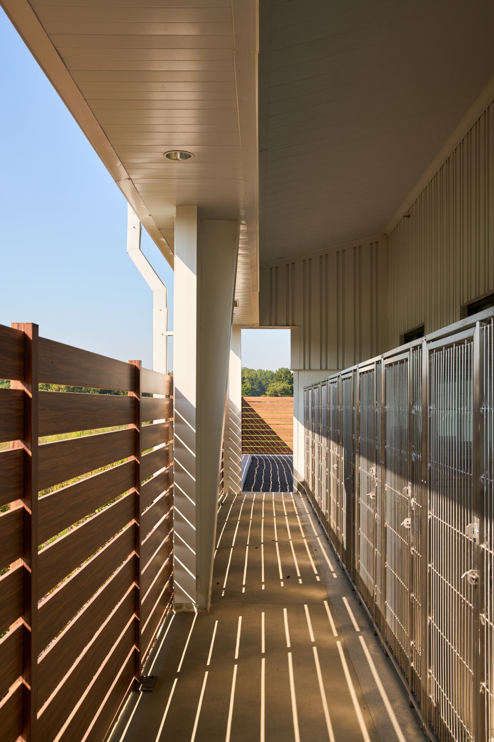 Covered porch and slatted wood screen along the kennel wing at Jefferson County Animal Control, photographed by Omar Mohammad Studio