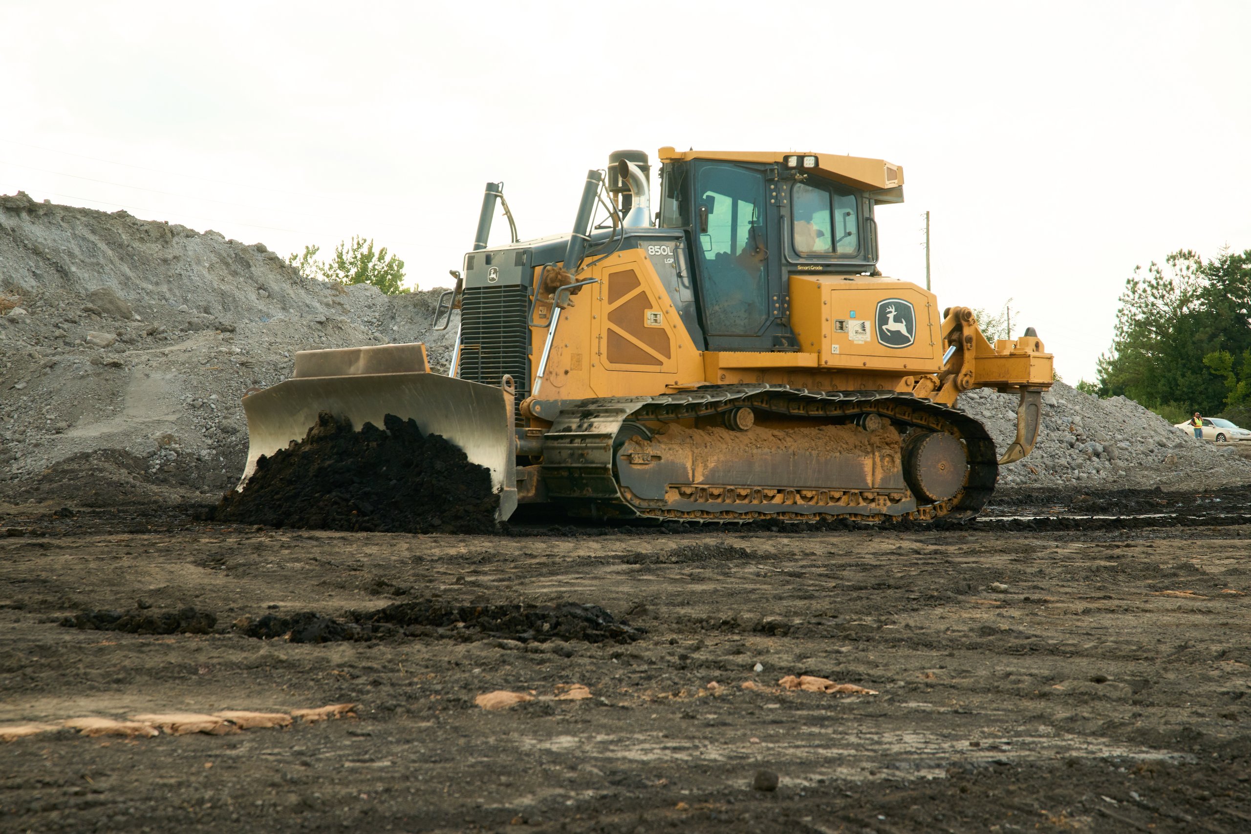 Dozer blade pushing dark fill at the Coalburg site for Cooper Construction, photographed by Omar Mohammad Studio
