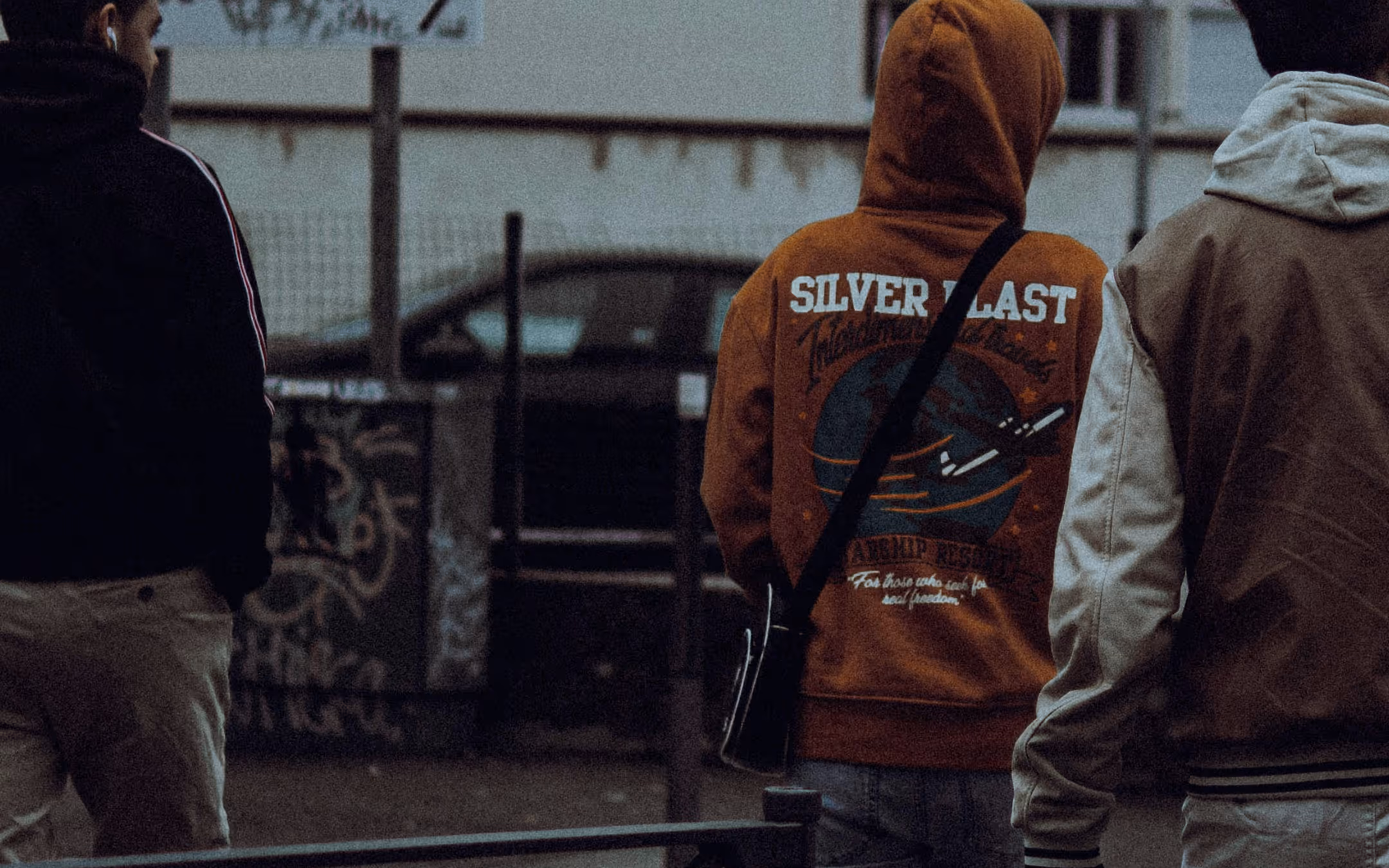 Three young men walking outdoors