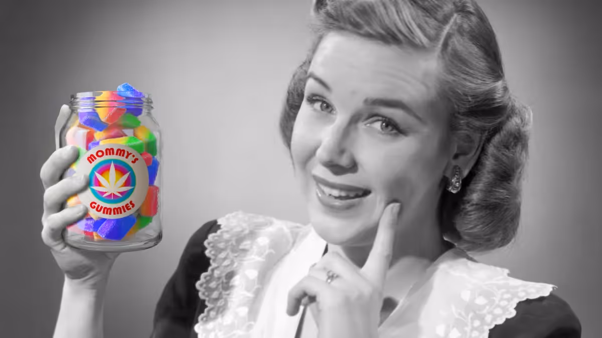 Black and white image of a 1950s era white woman holding a colorful jar filled with cannabis gummies