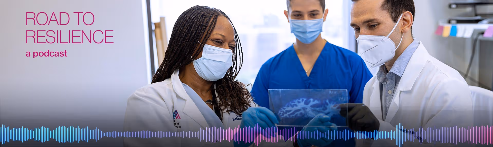 Image of Dr. Hurd and two others in masks and scrubs talking