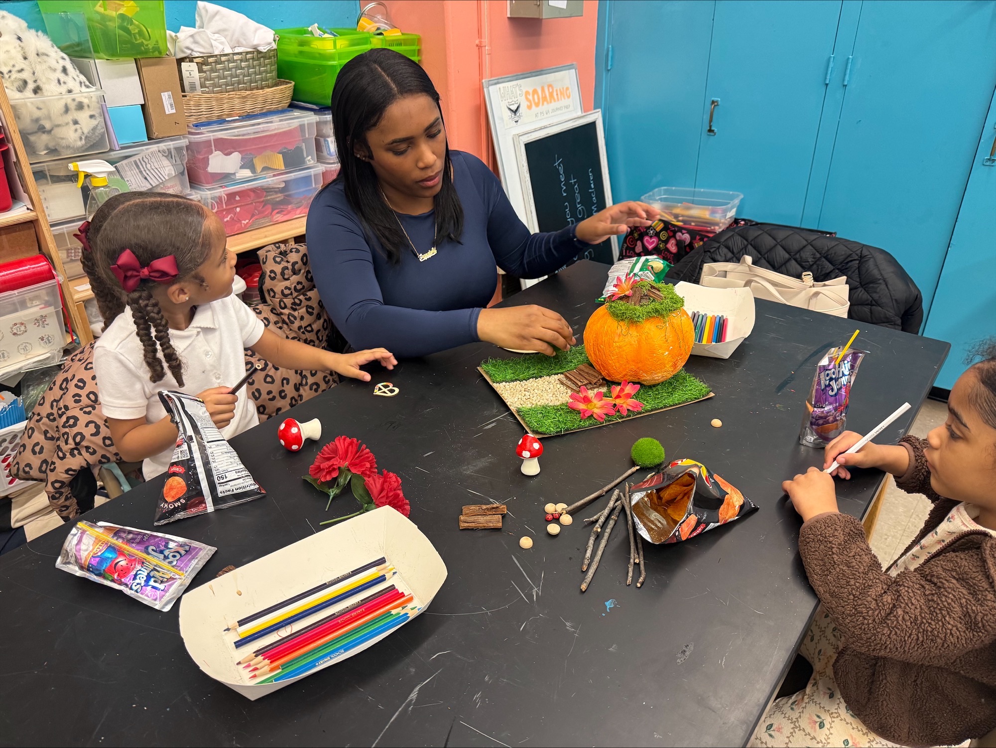 Adult helping child make a craft model