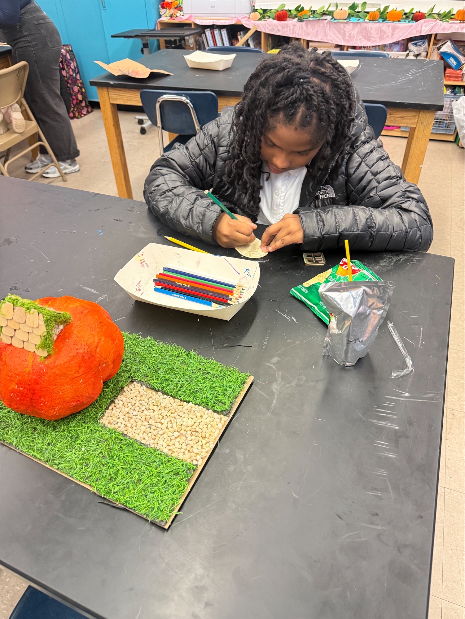 Child working on a craft at a table