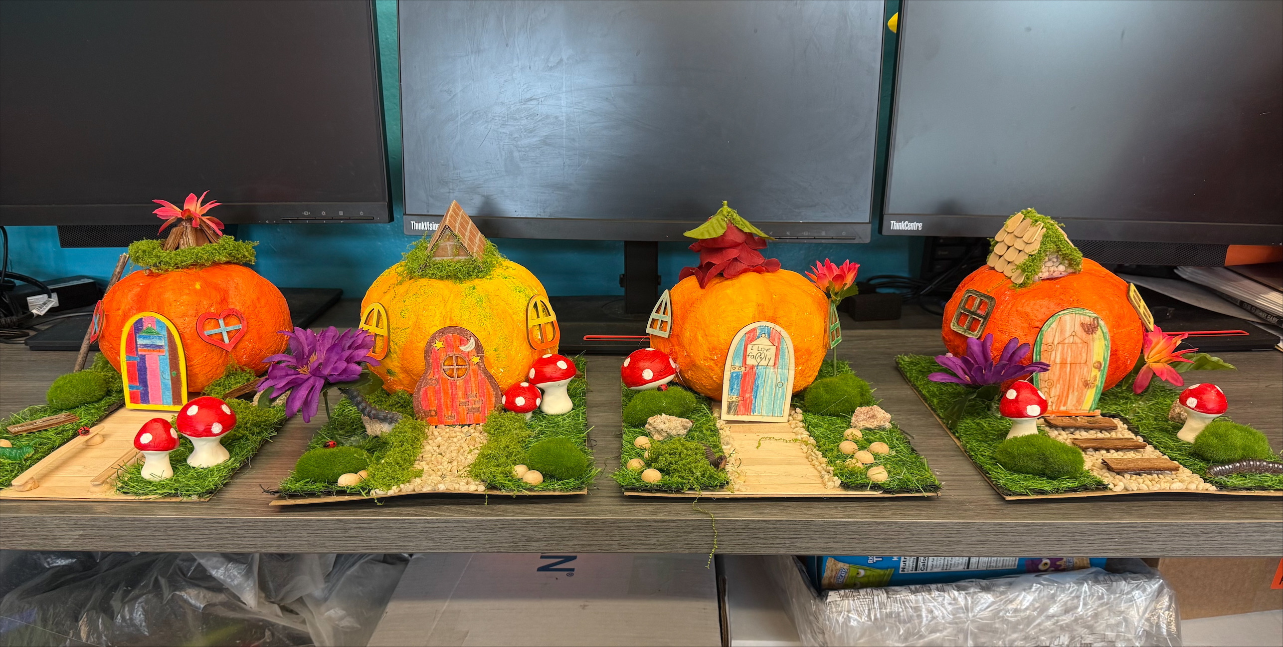 Two pumpkin craft houses on display