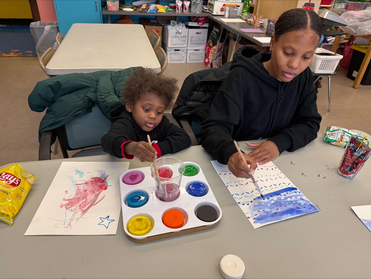 Kids painting with colors at a table